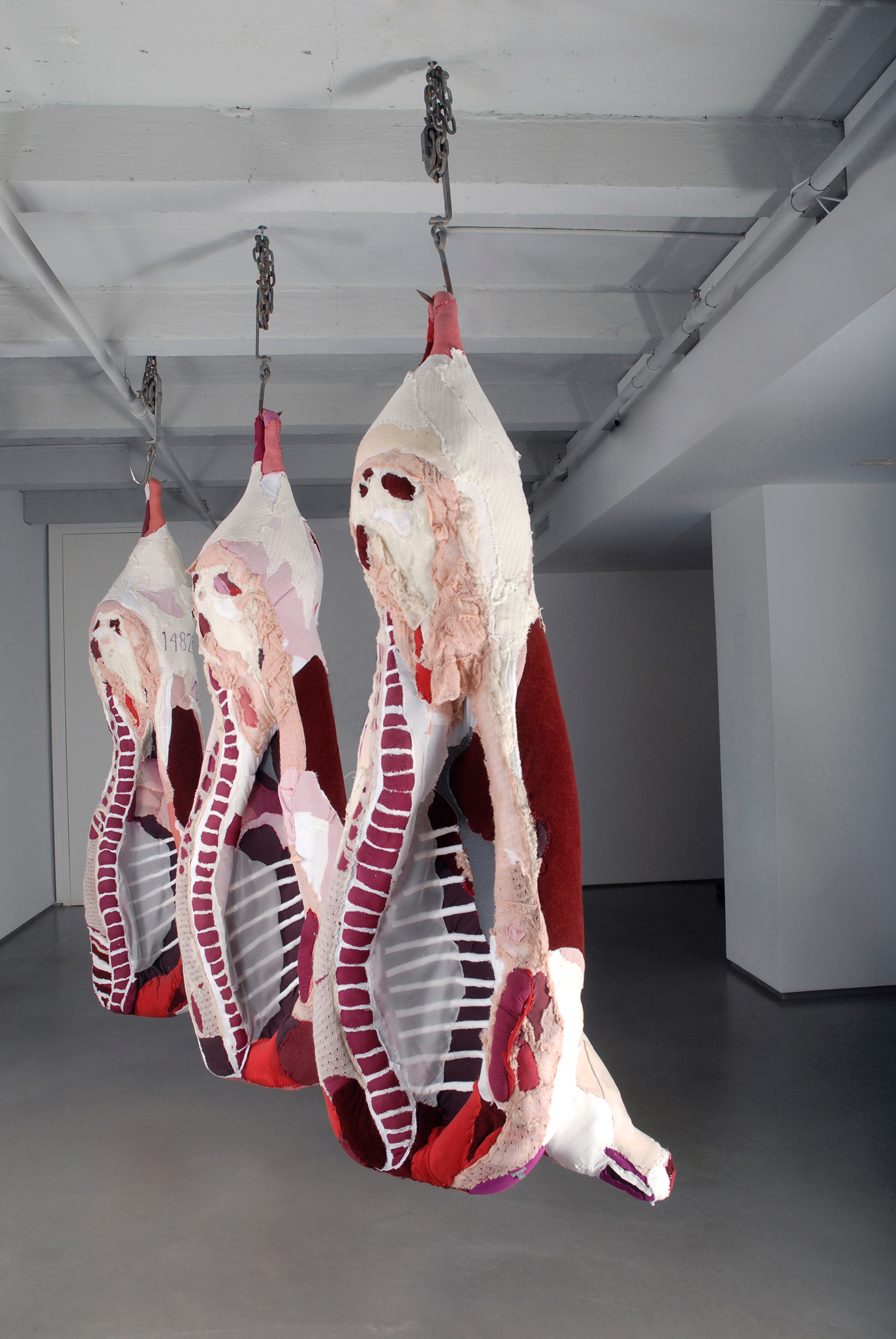 "Abacus" 2008 | Discarded Clothing, Metal Hooks, Chains | 96 x 36 x 45 in. (Each Carcass)