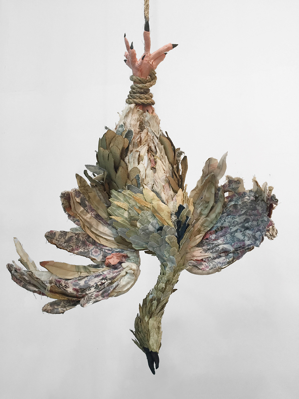 "Immanence" 2017 | Upholstery Fabric, Discarded Clothing, metal hook, chain | 18 x 24 x 15 in.