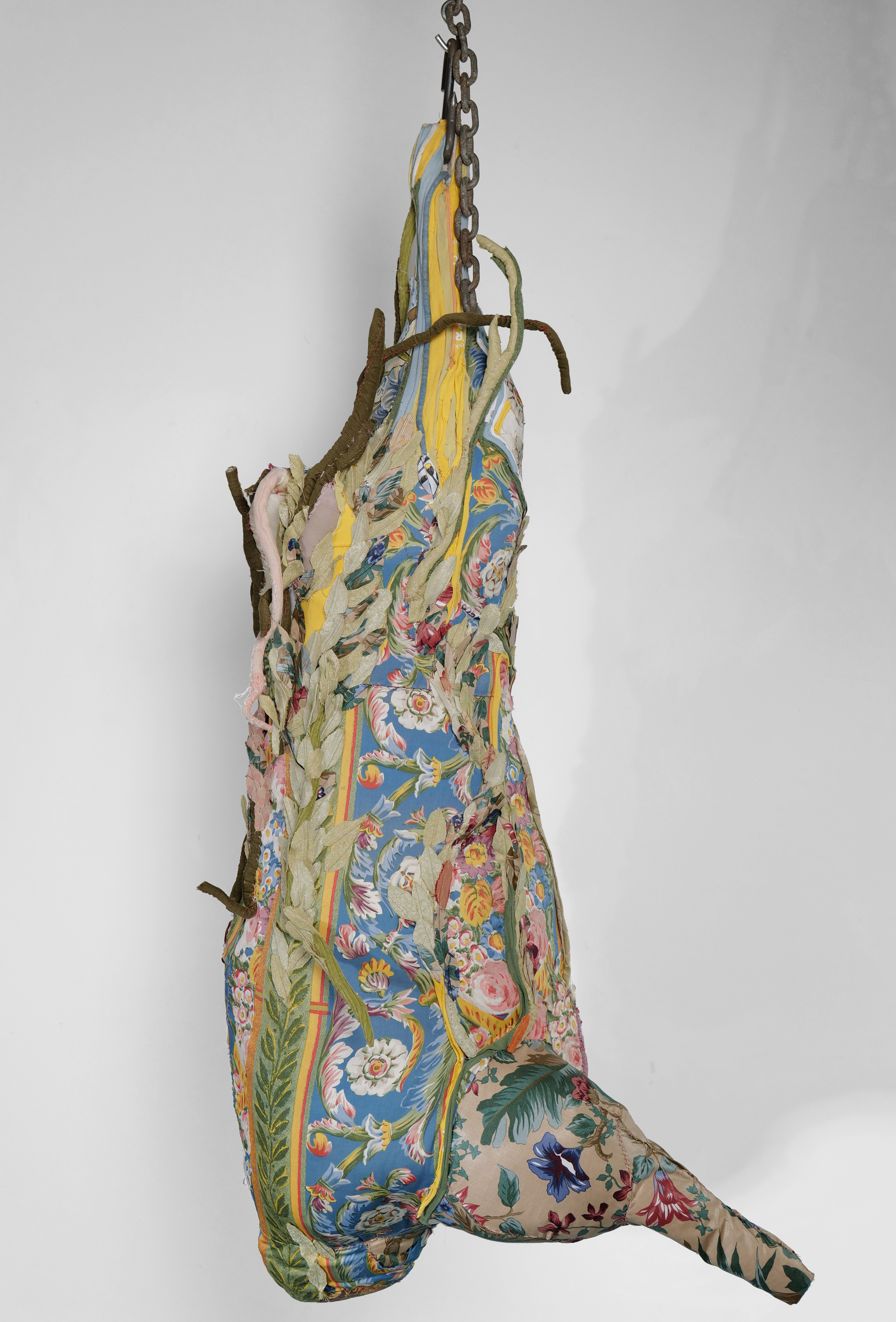 "Cow Turns into a Landscape" 2021 (Back view) | Discarded clothing, metal chains, meat hooks | 68 x 16 x 29 in.