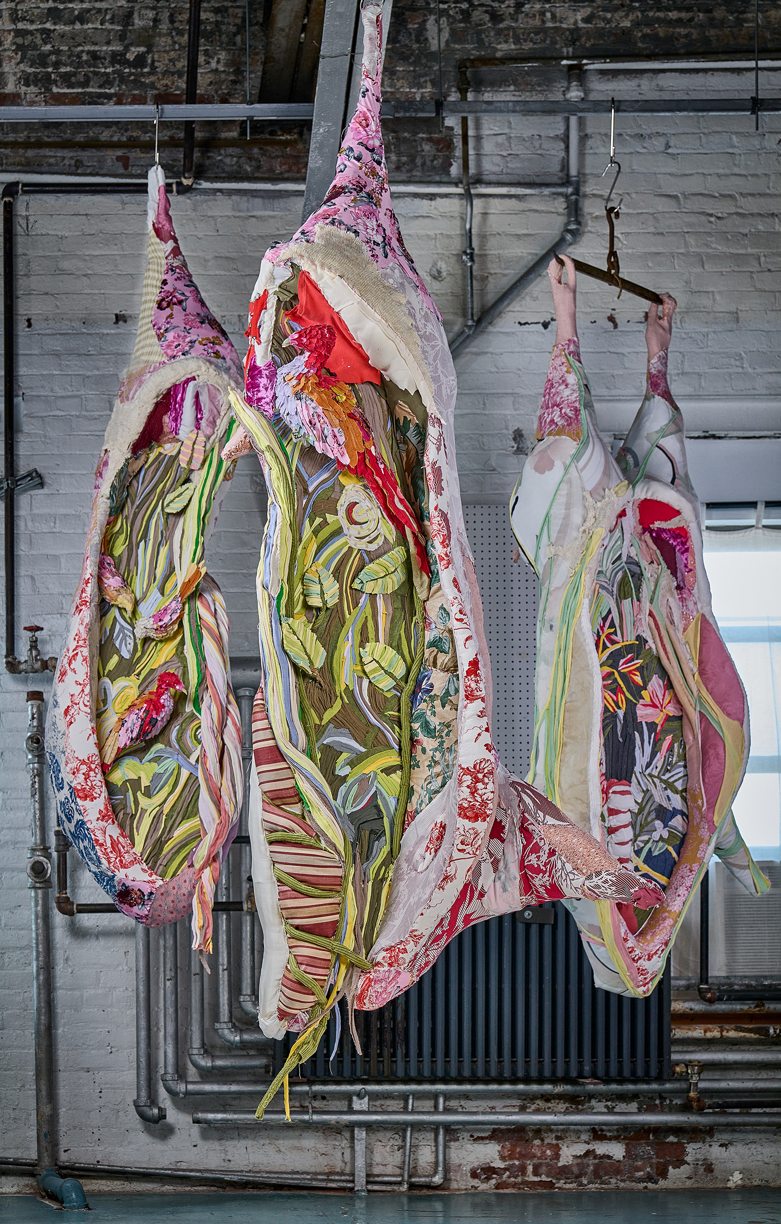 "Tropical Abattoir" 2021 ( Studio shot) | Discarded upholstery fabrics and other textiles, acrylic nails, chain, motor 