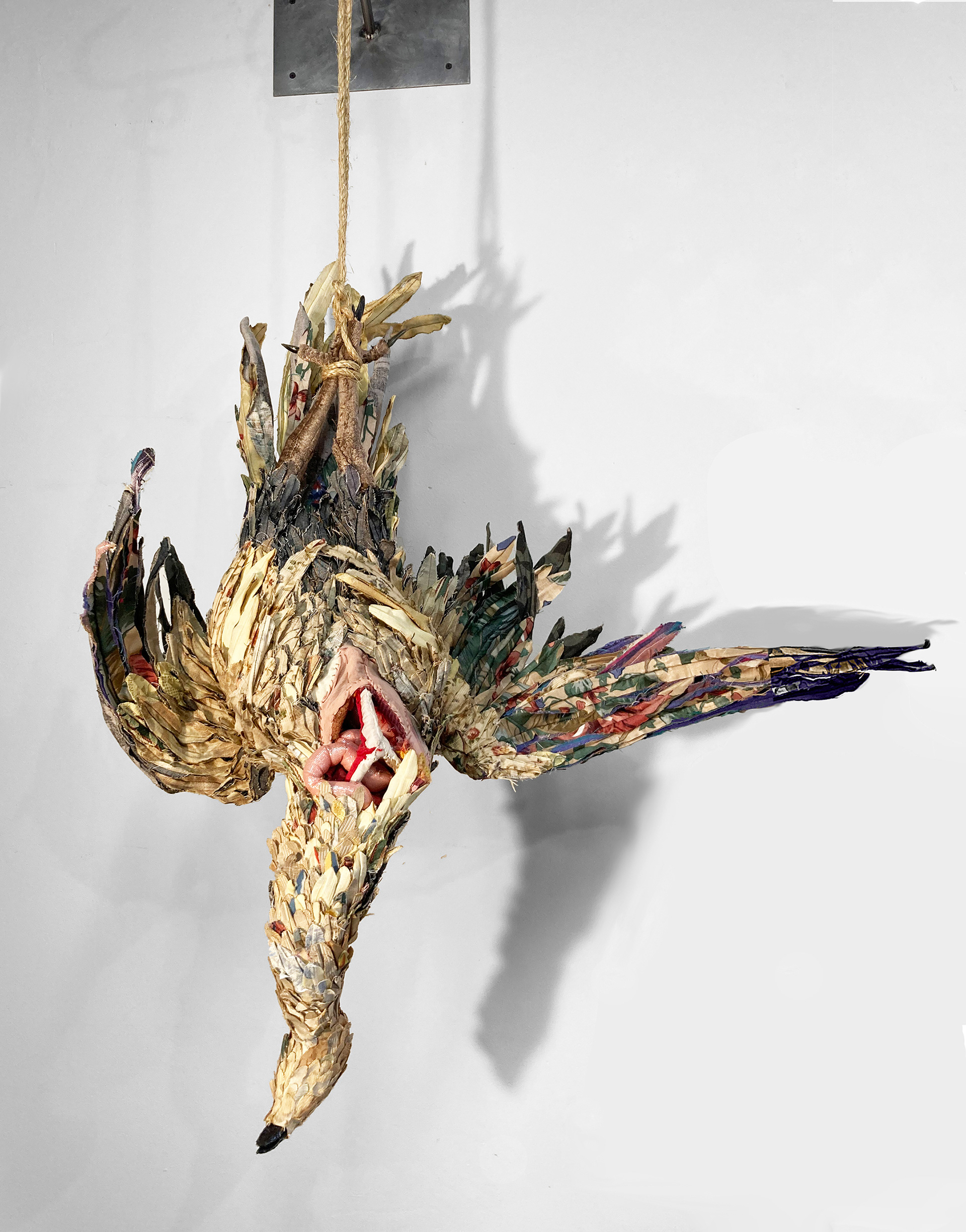 "Dead Bird with Open Chest" 2021 | Discarded Upholstery fabrics, Meat Hooks | 36 x 30 x 10 in.