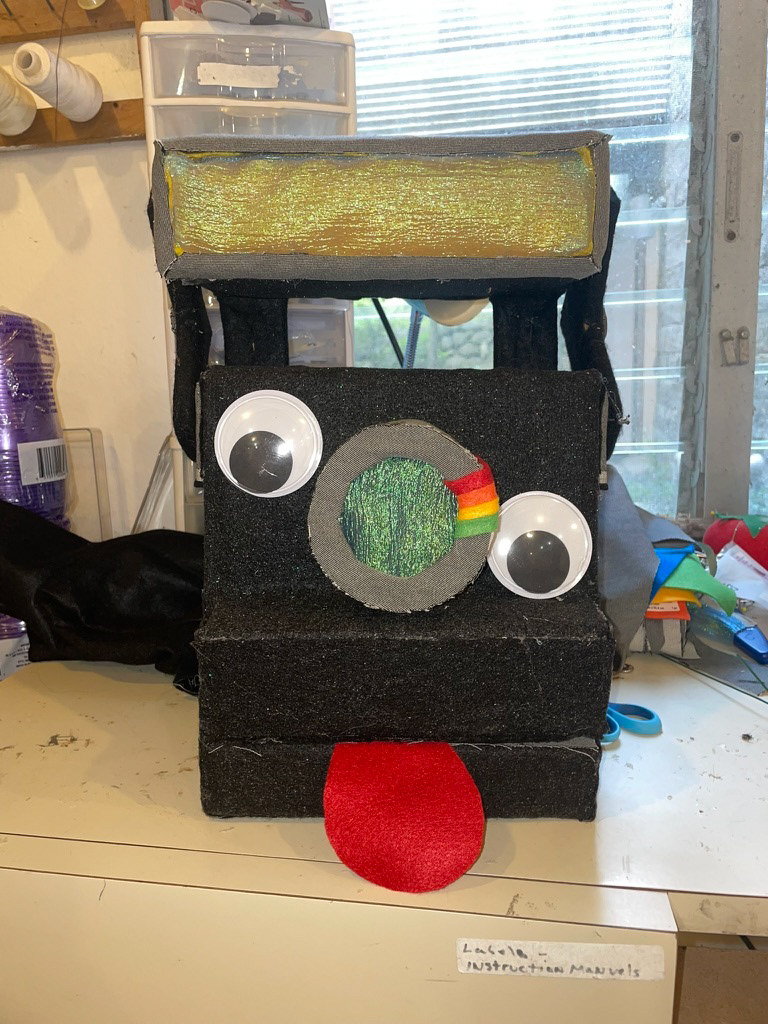 Polaroid puppet, "Camp U"