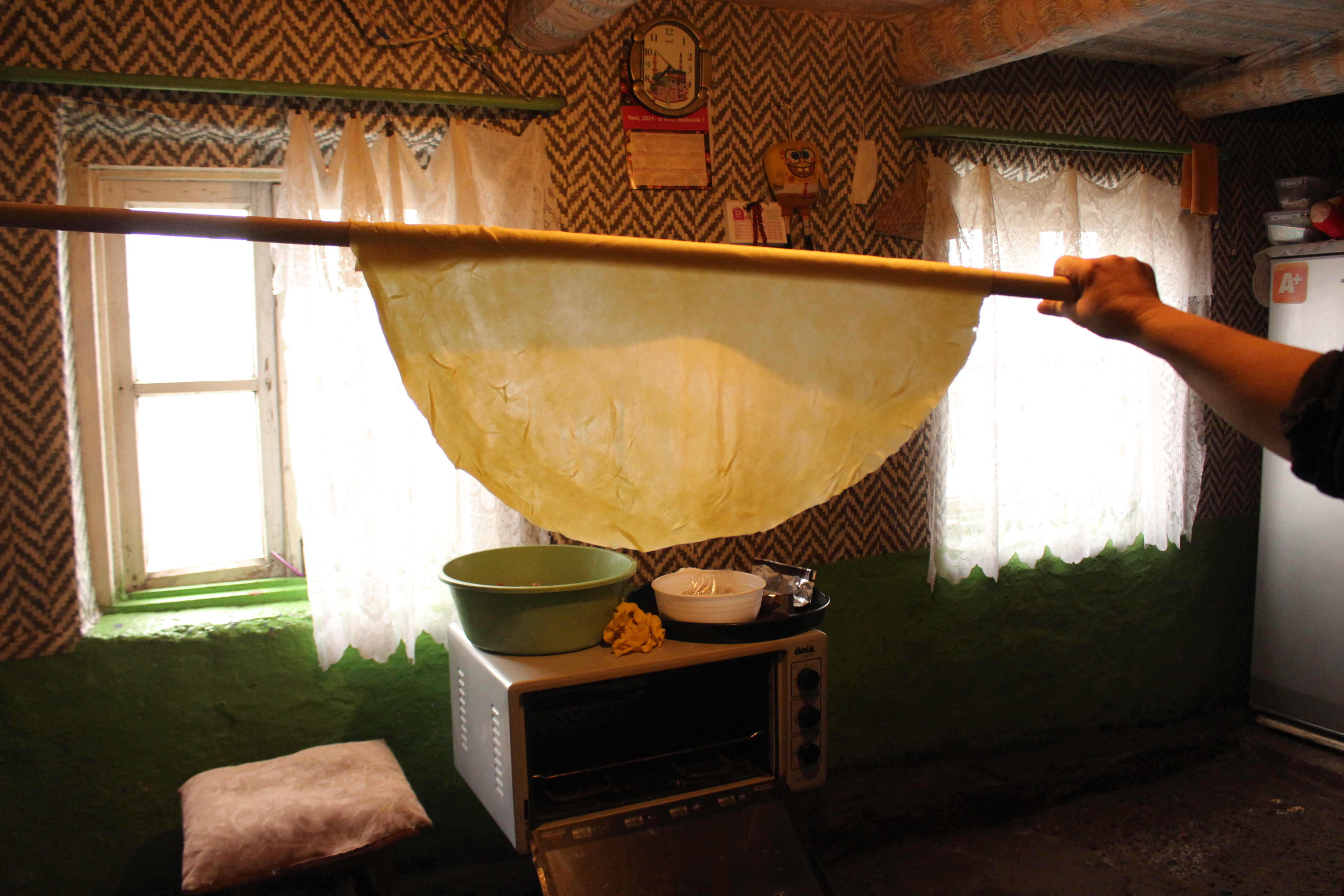The wafer - thin dough Yetar rolled to make Shorgoghal, a must - have bun on every family's table on Novruz Bayrami. Shaped like a roll, it symbolizes the Sun.  Yetar’s recipe: Knead dough made from butter, vanilla, salt and eggs. Leave it to rise. Make about 12 balls from the dough and roll each of them into thin discs. Stack the flattened round pastries and sprinkle with melted butter. Cut the discs into stripes, placing a mix of walnuts, sugar and cloves in the center. Roll each strip slightly , folding the dough from the top and bake. A sprinkle of Zira (cumin) on top of the bun is the last touch.