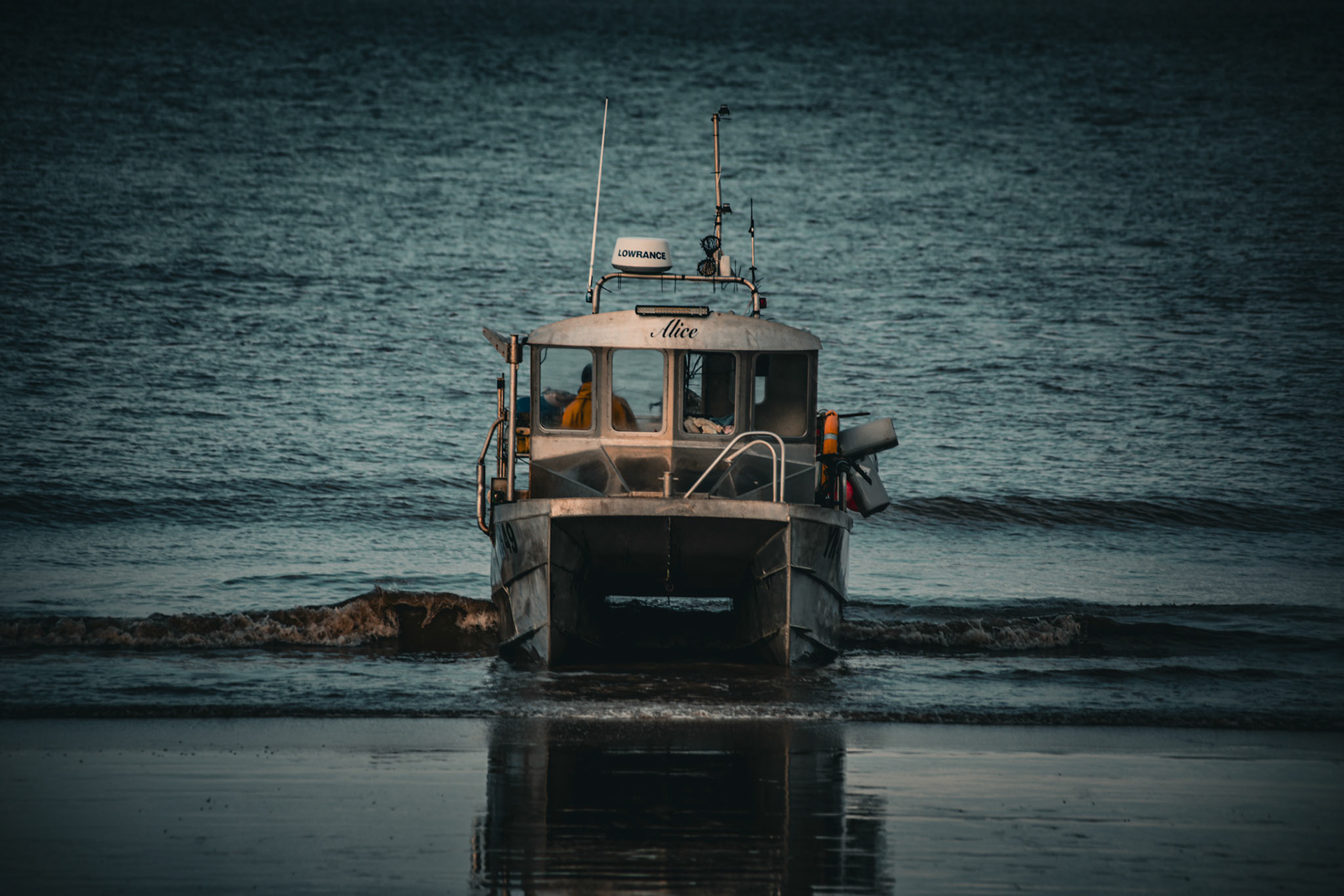 The gentle lapping of waves whispers tales of adventure as the steadfast vessel, 'Alice', awaits her next voyage into the endless expanse of the sea.
