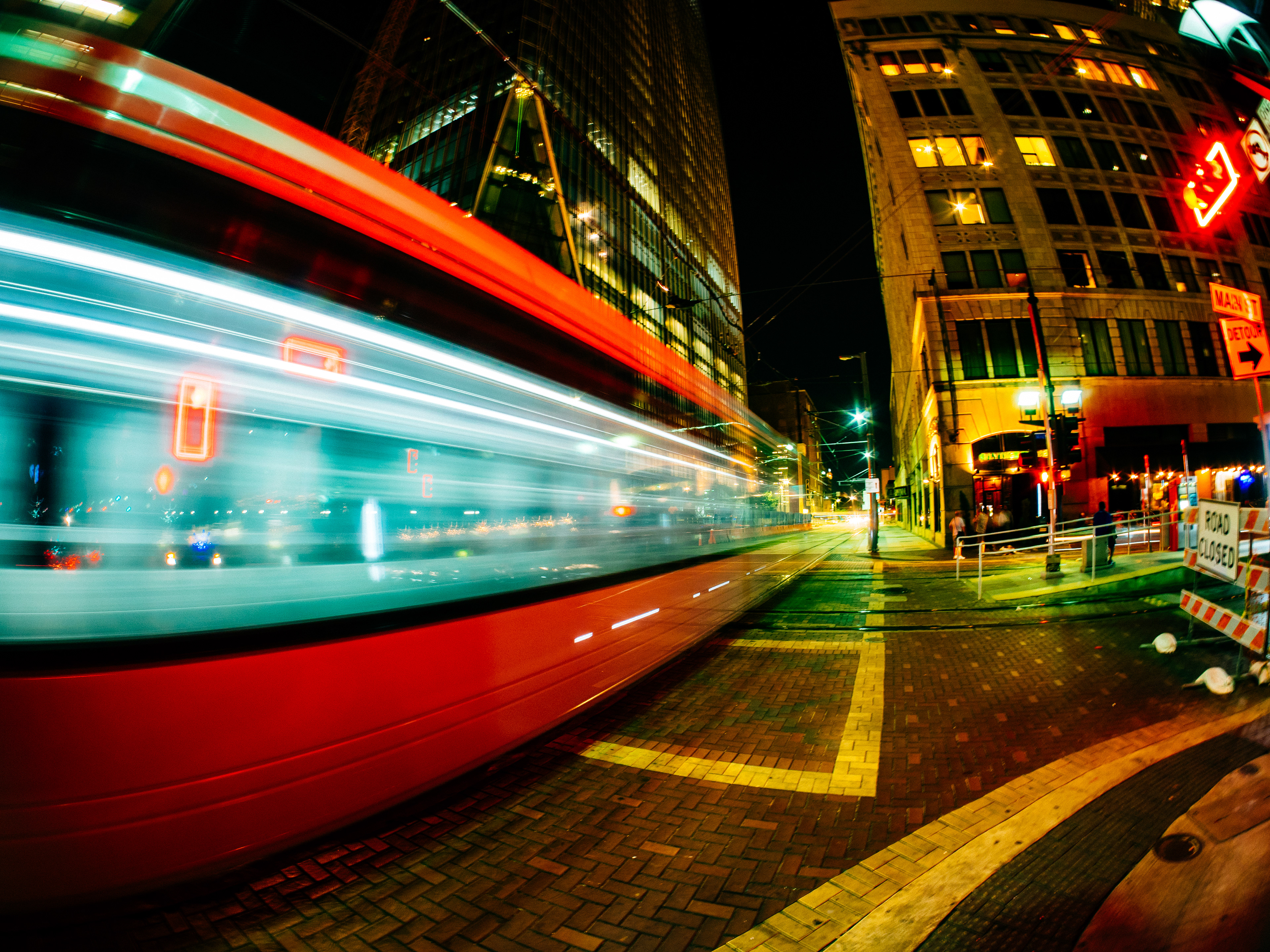 The trolly goes pass me as I stand on the sidewalk in downtown Houston, Texas, USA.