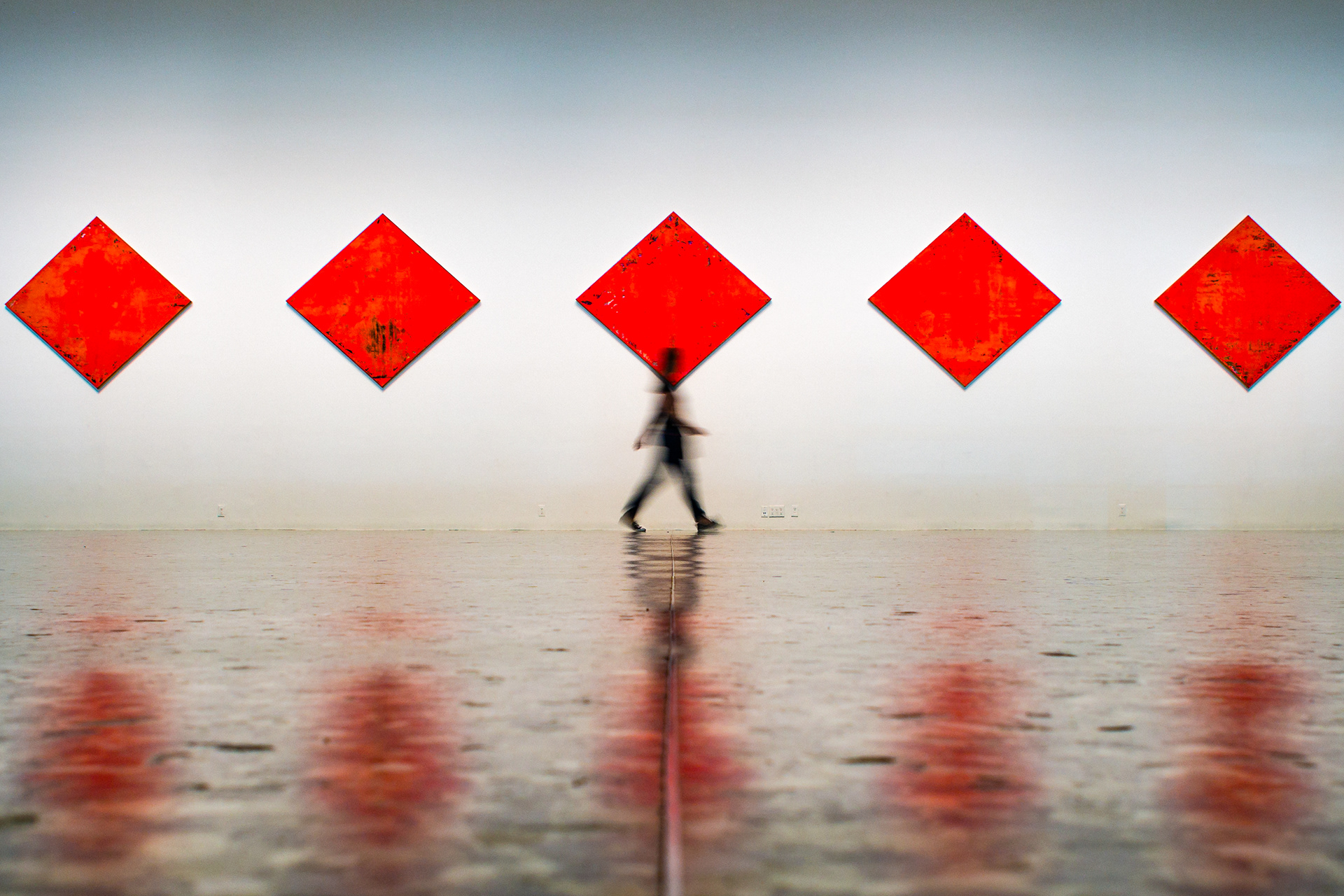 A friend walking past an art installation at The Museum of Fine Arts, Houston (MFAH) in Houston, Texas, USA.