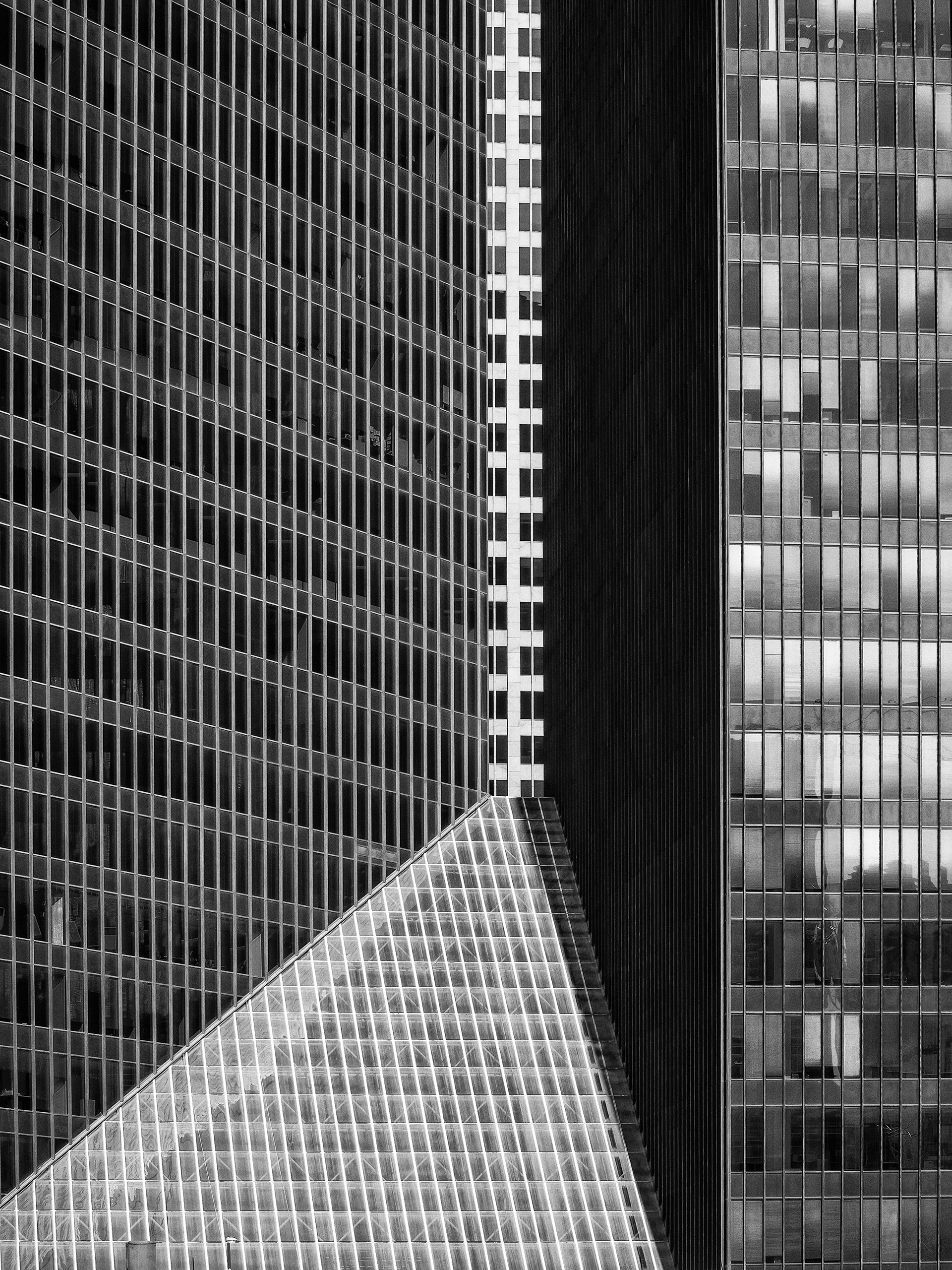 A white building can just barely be glimpse in the small space between two other buildings in downtown Houston, Texas, USA.
