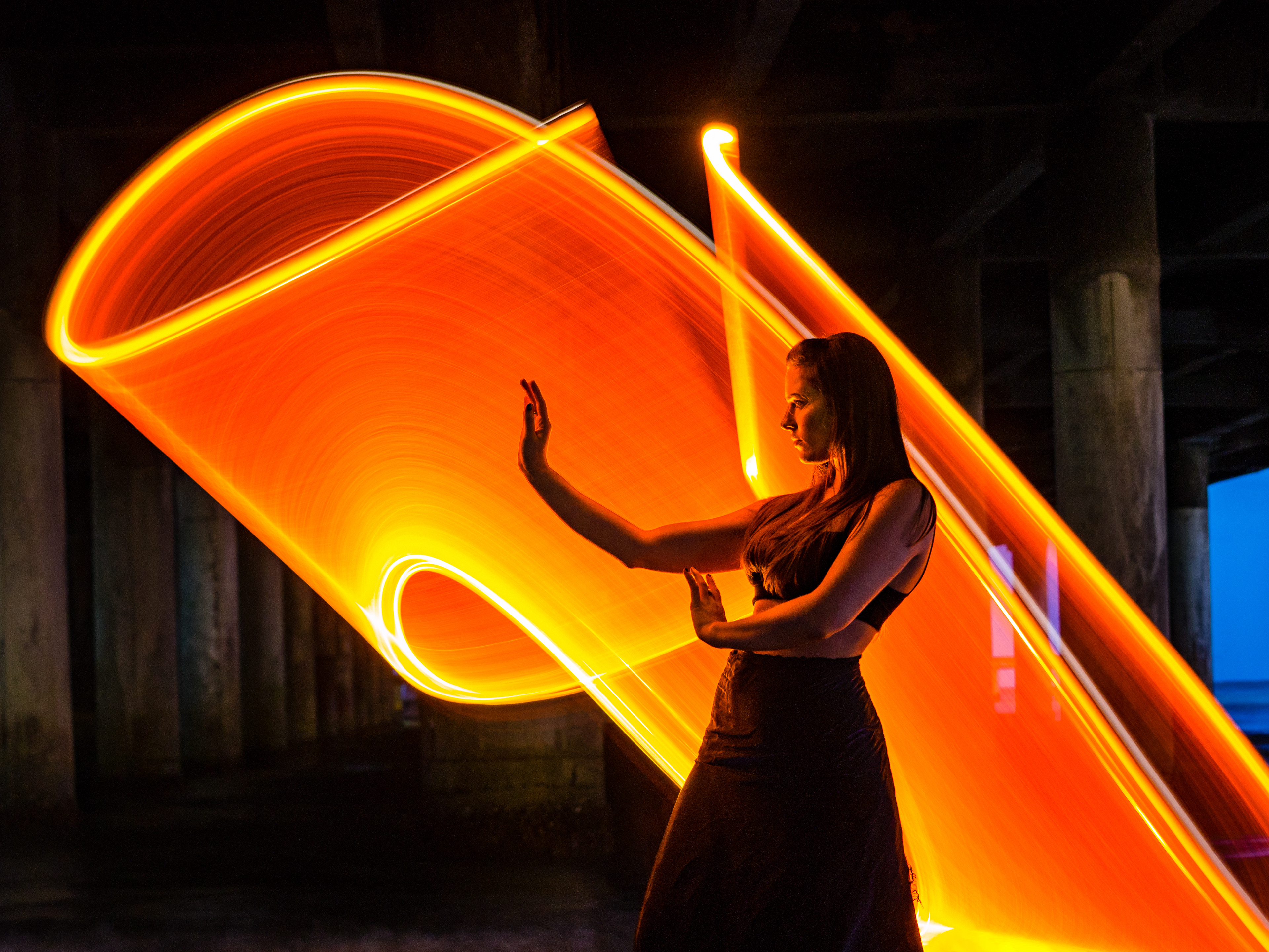 Light painting with Zach from Zach Alan Photography and Juli Thornton modeling under Pleasure Pier in Galveston, Texas, USA.