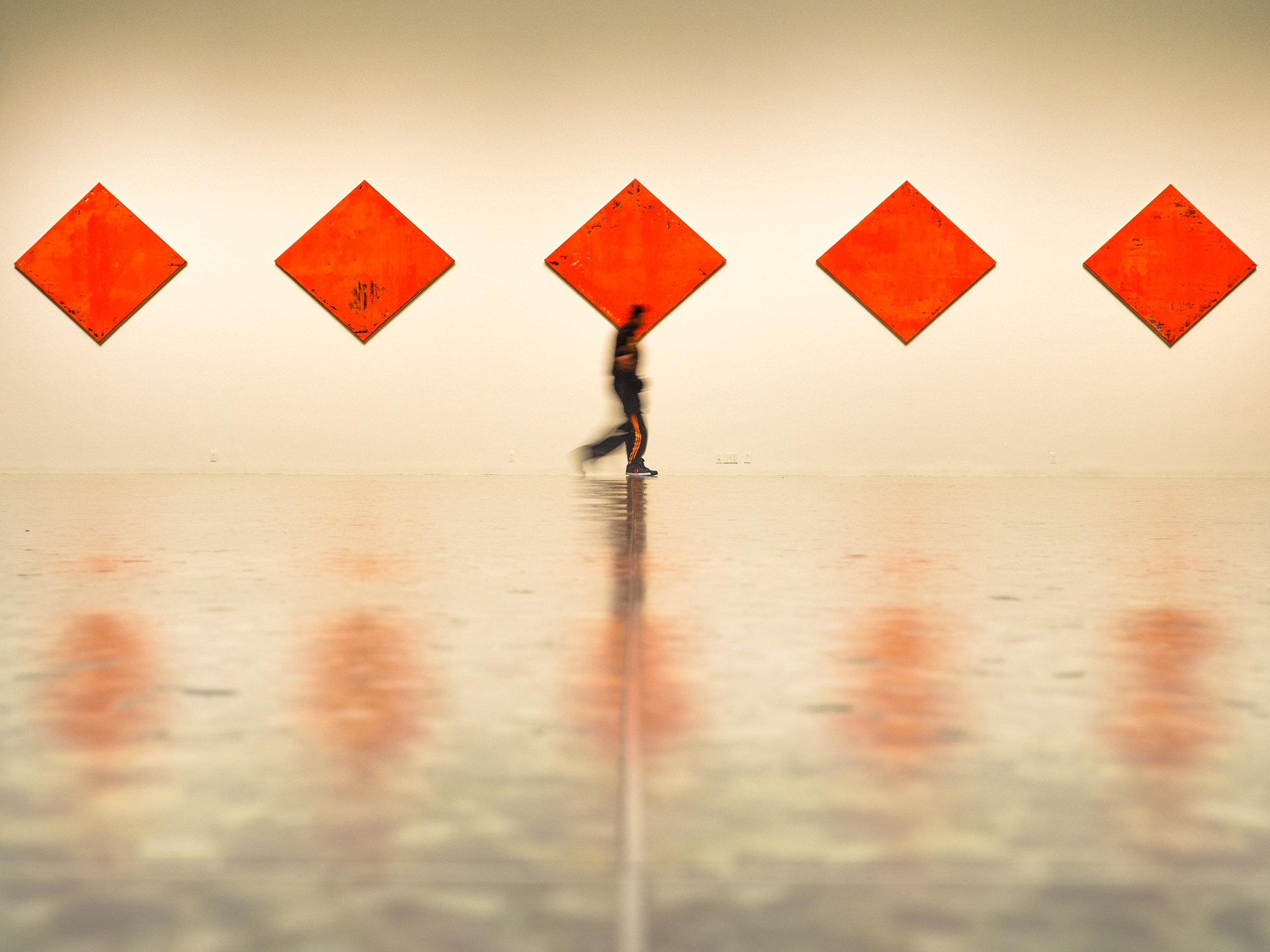 A person walking past an art installation at The Museum of Fine Arts, Houston (MFAH) in Houston, Texas, USA.
