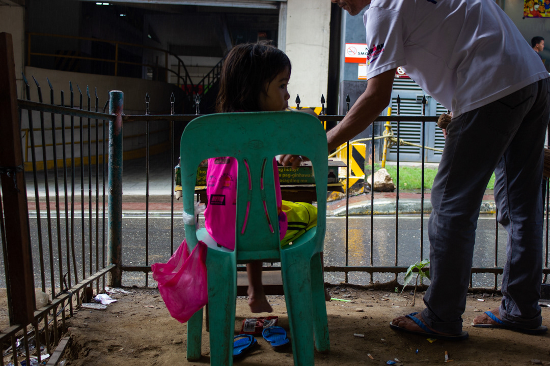 This 3 year old girl was living under an underpass, selling cigarettes opposite a McDonalds. I bought her a meal with a toy. Further down the underpass her younger sibling was wrapped up and sleeping on a dirty mattress. Cebu, Philippines.