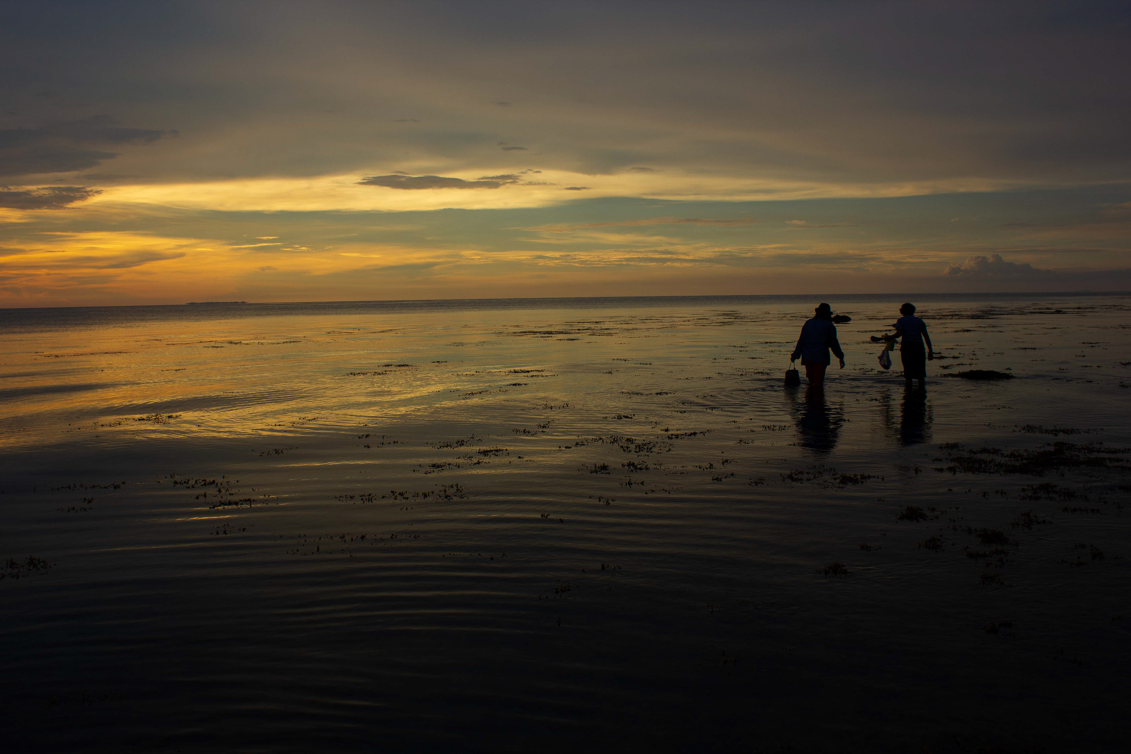 My Step-Lola and her friend fishing for mussels. Leyte, Philippines.
