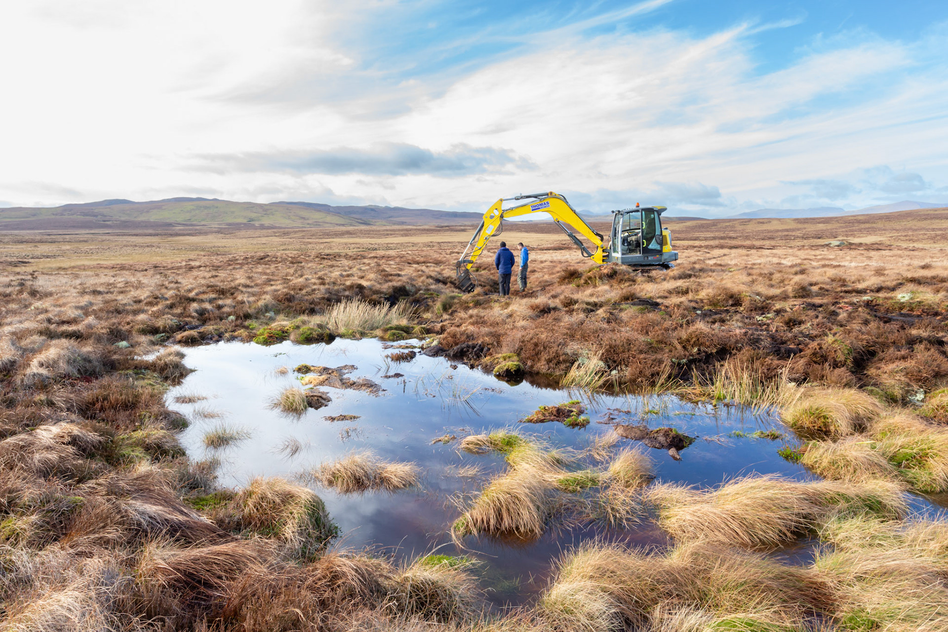 Consevation officer &amp; contractor viewing peatland restoration work on Migneint moors, Winter, North Wales, UK