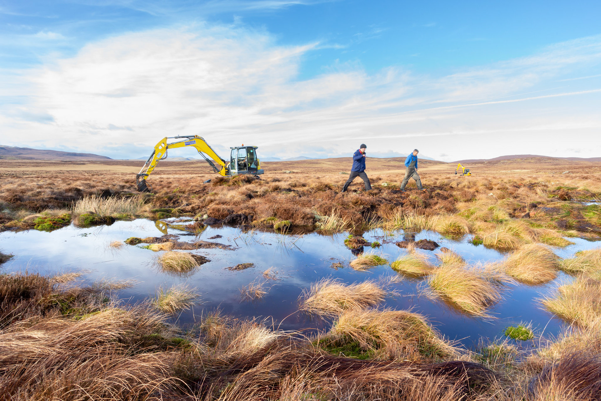Consevation officer &amp; contractor walking next to pool, discussing  peatland restoration on Migneint moors, Winter, North Wales, UK