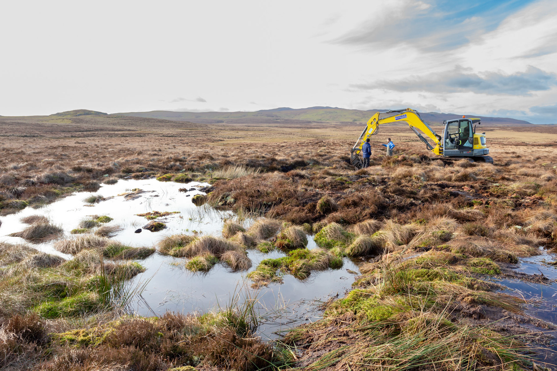 Consevation officer &amp; contractor discussing peatland restoration work on Migneint moors, Winter, North Wales, UK .