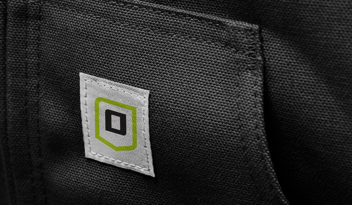 Close-up of Onguard Protective Workwear jacket pocket showing branded label and stitched brand mark as part of the workwear brand rebrand.