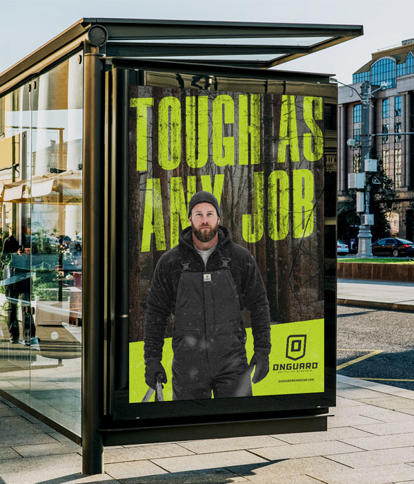 Bus shelter advertising campaign for Onguard Protective Workwear featuring the “Tough As Any Job” message and brand identity.