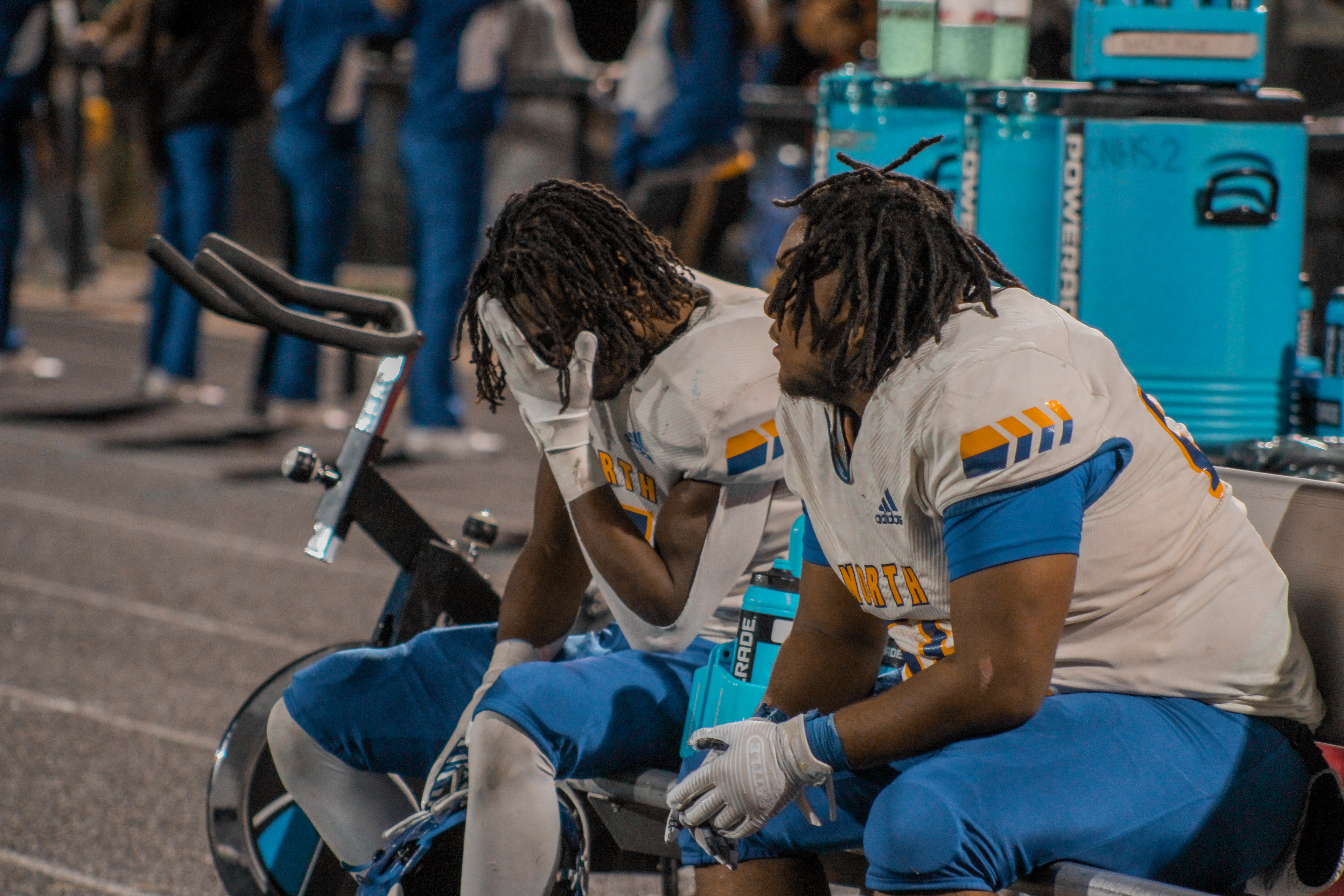 Senior players from Omaha North sit in defeat as they loose their last game to the Warriors in the final game before the State Championships.