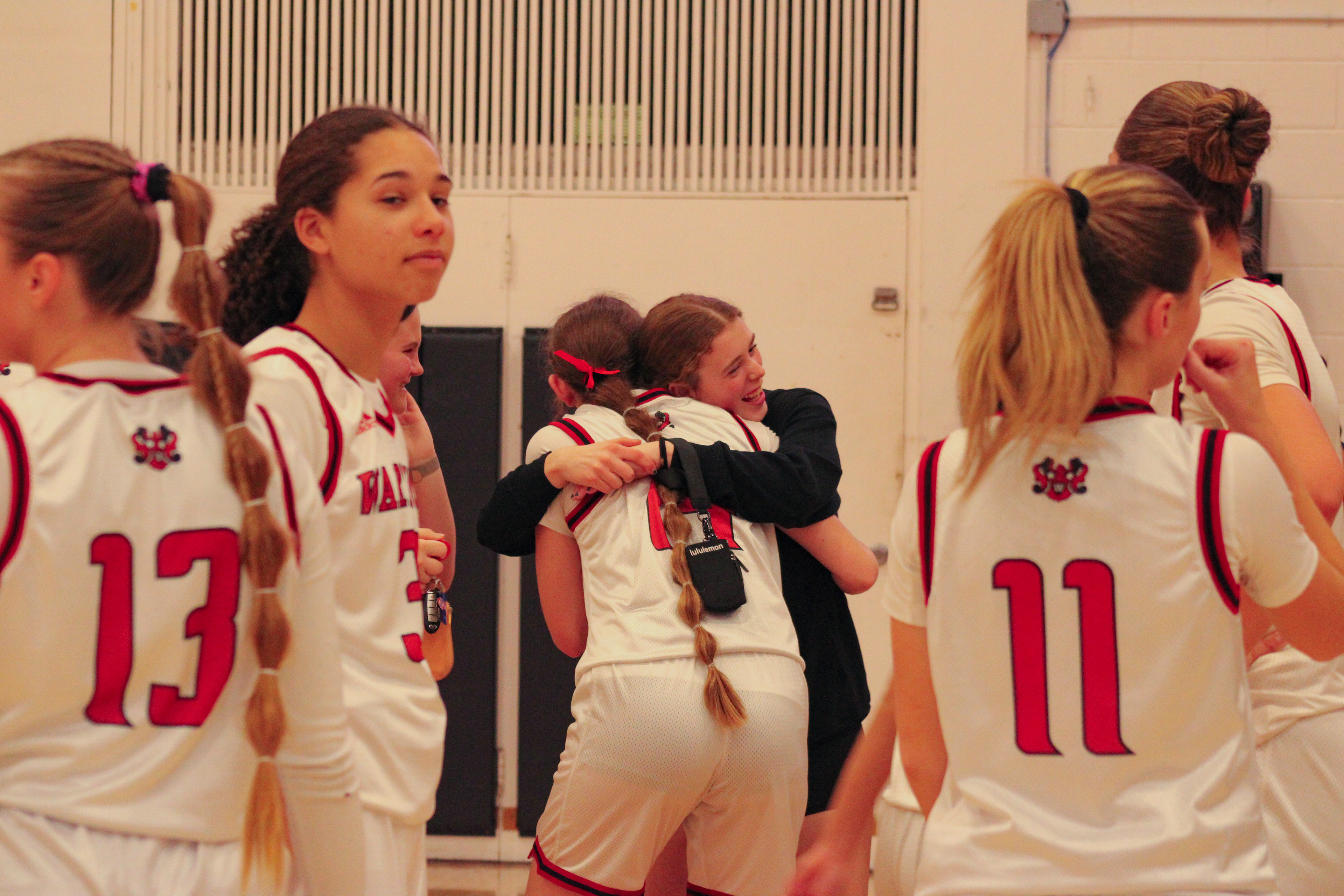 Gueryn Kay hugs a friend after winning the Class A District Championship.