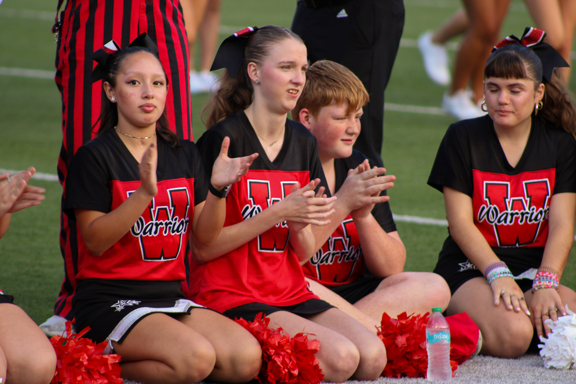 The Sparkles Cheer Team applauds the Red Shield.