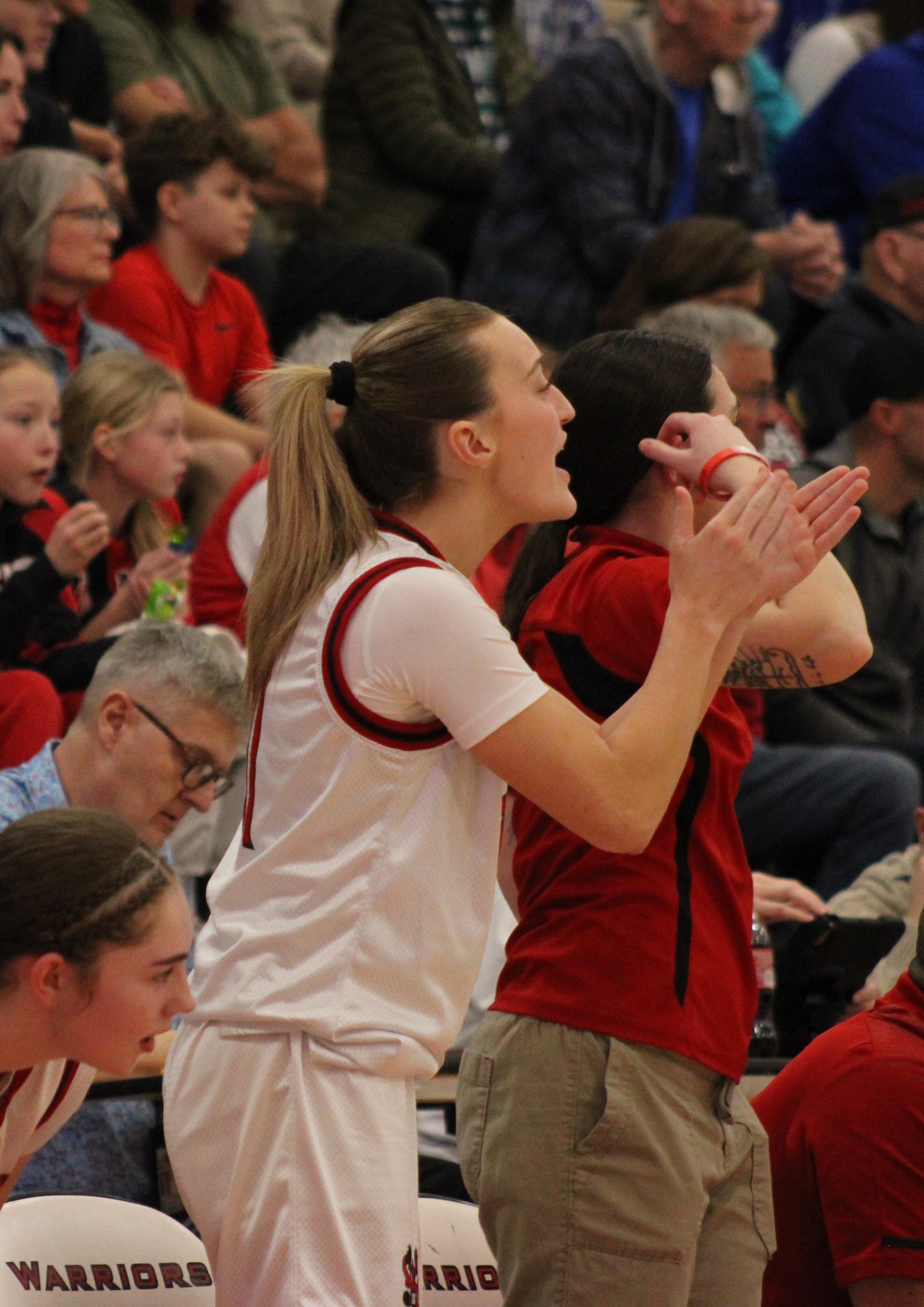Senior Gabbie Duval cheers on her teammates from the sidelines.