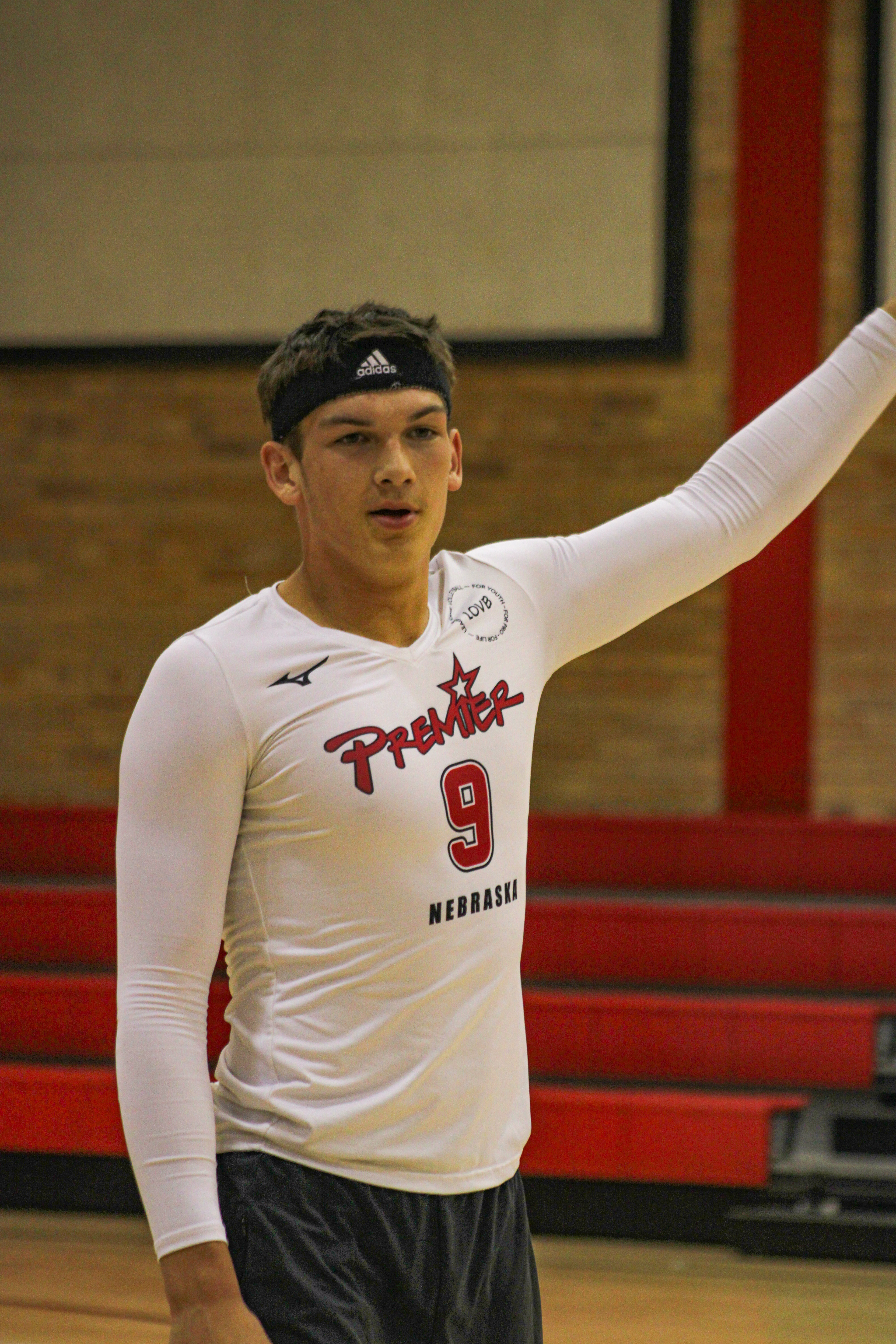 Junior Trea Spady holds his hand up to signal who's turn it is to serve in the annual Powder-Buff game.