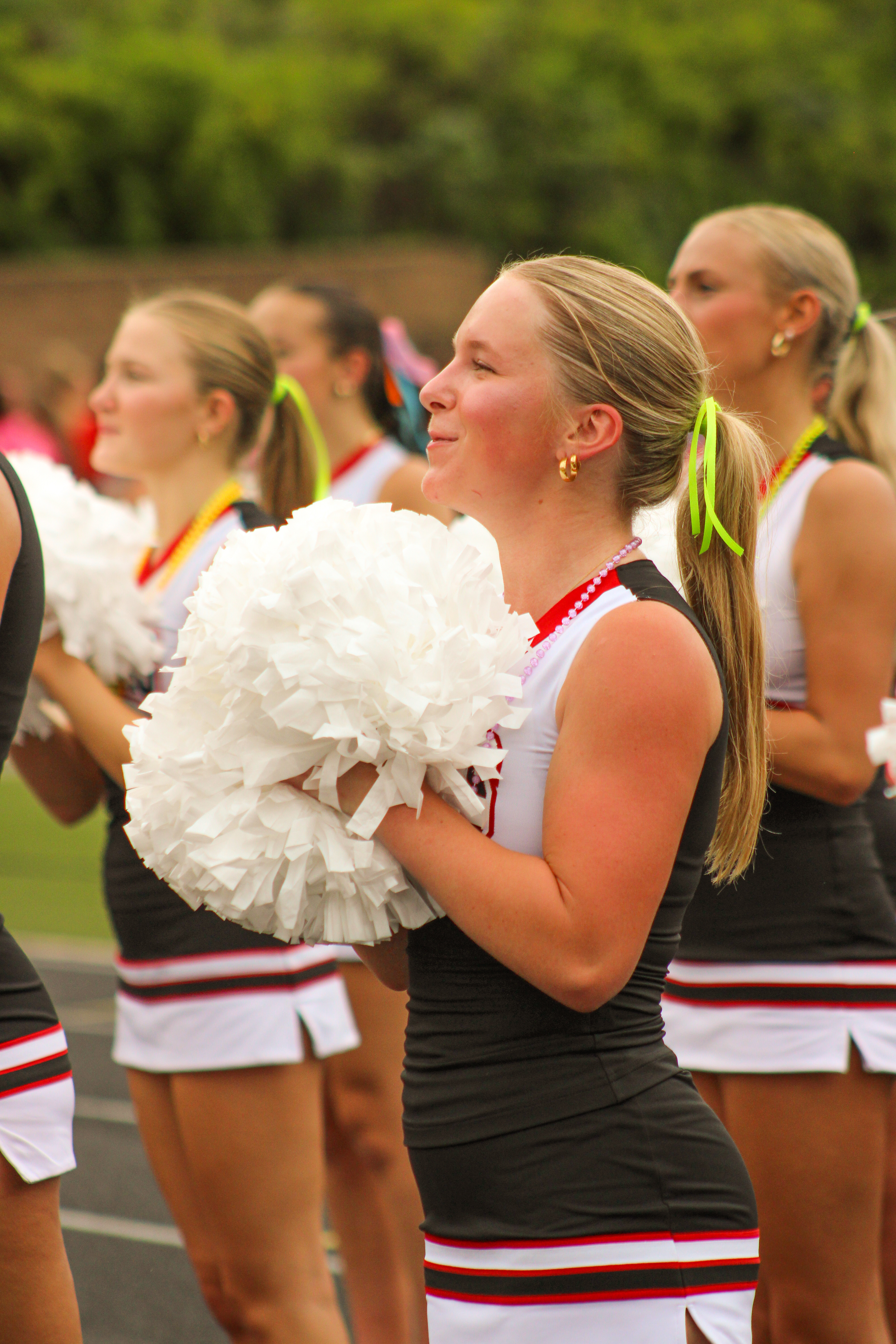 Junior Hadley Hanson leads the student section in a game day cheer.