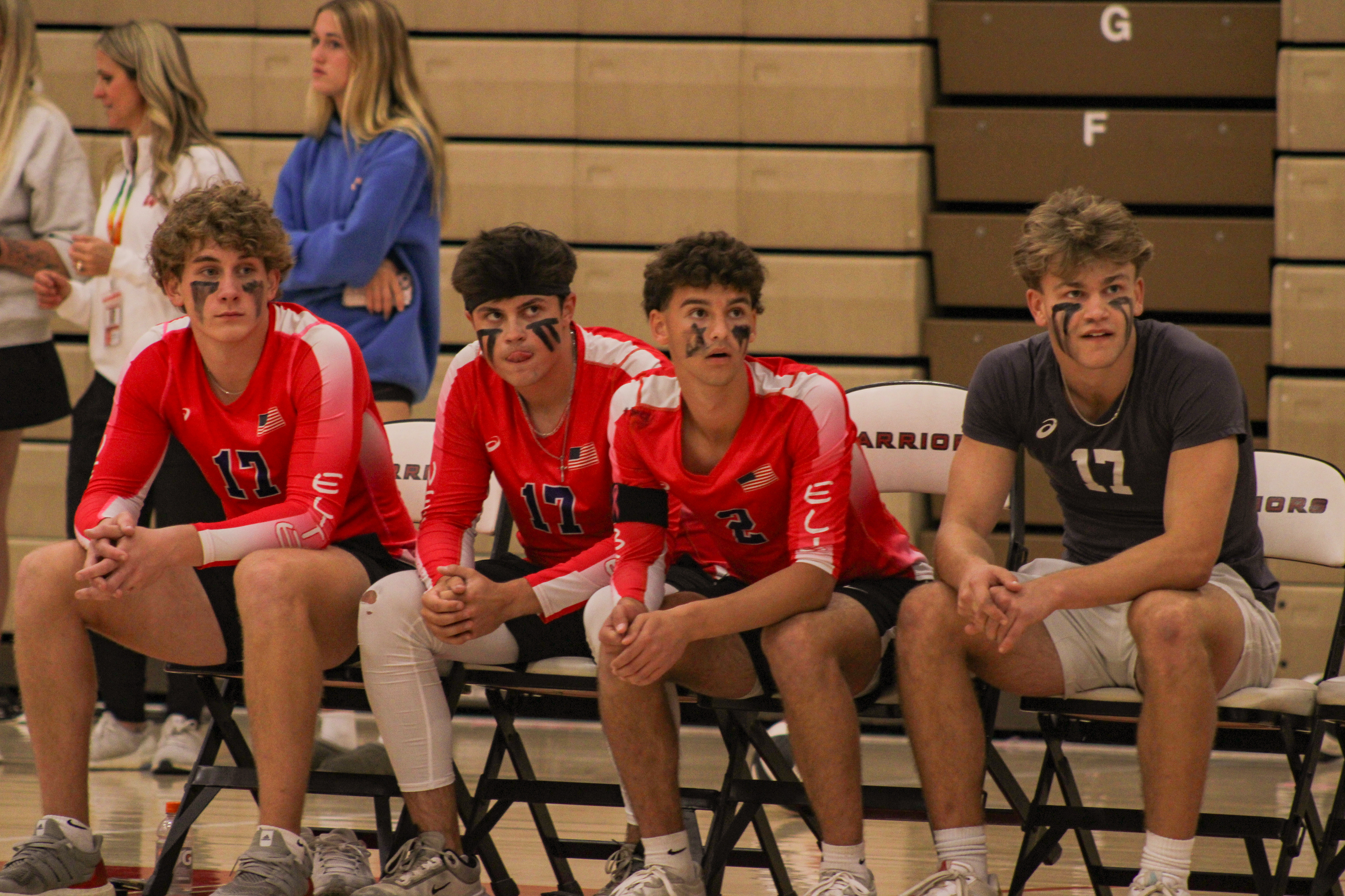 Seniors Chase Davis, Charles Dodge, Cody Myerson and Drew Long watch their teammates serve a winning ball.