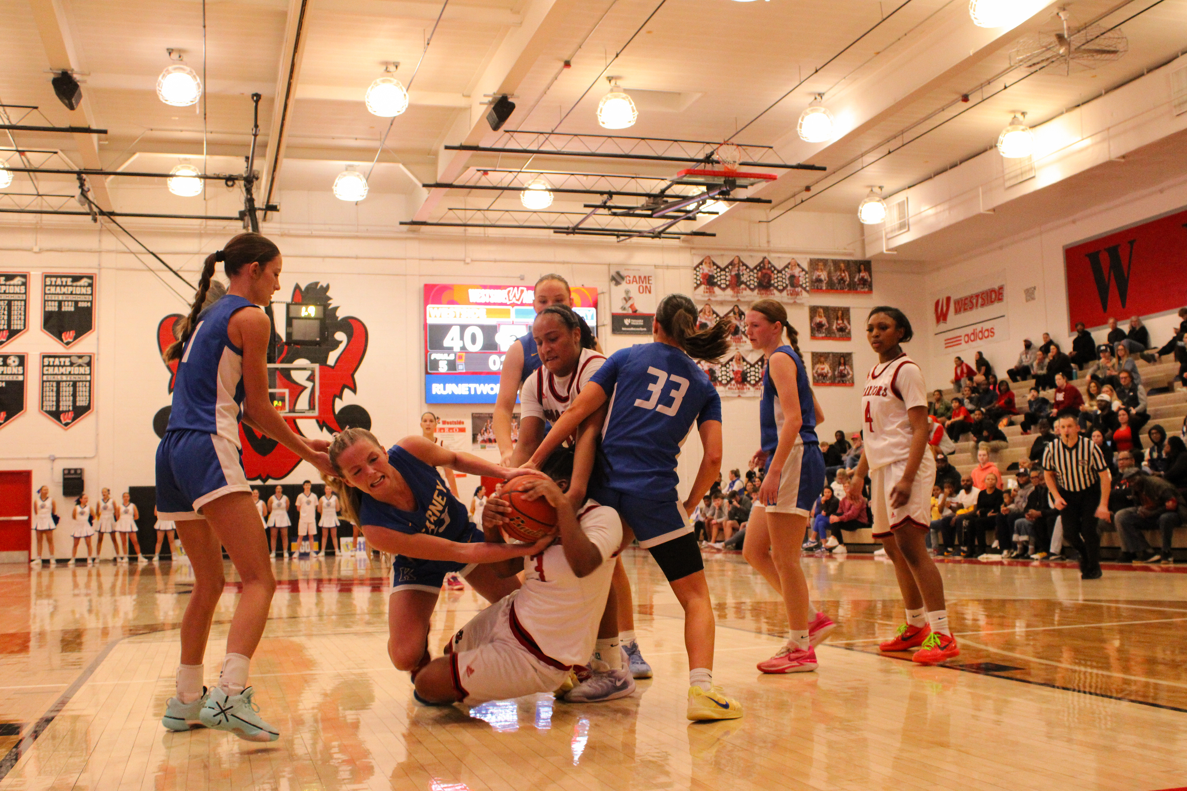 Himayajo Metoyer falls to the ground while trying to hold on to the ball.