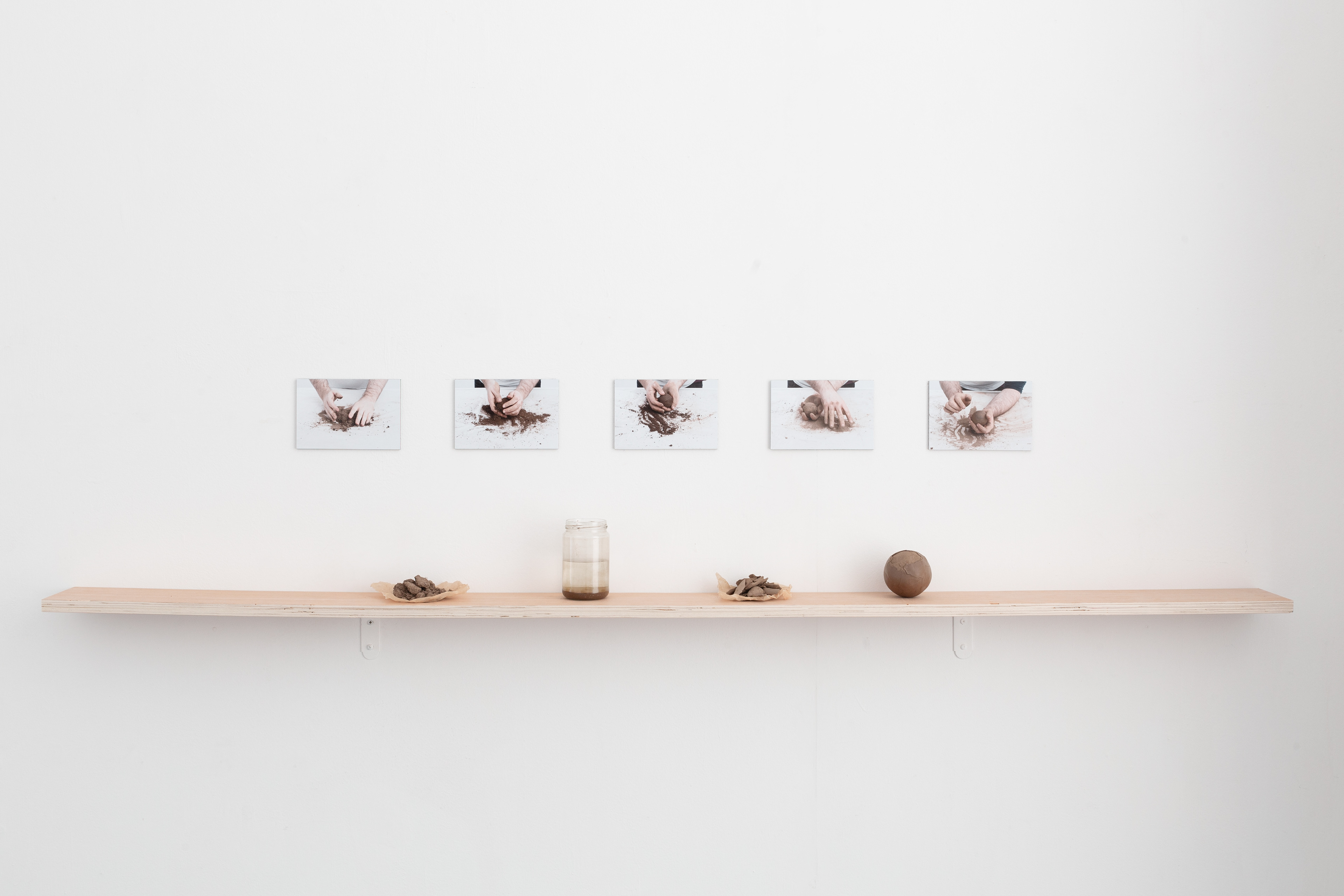 92.7km 2020 5 photographic prints, soil, water, glass, plywood 11.5 x 174.3 x 37.8 cm, installation view