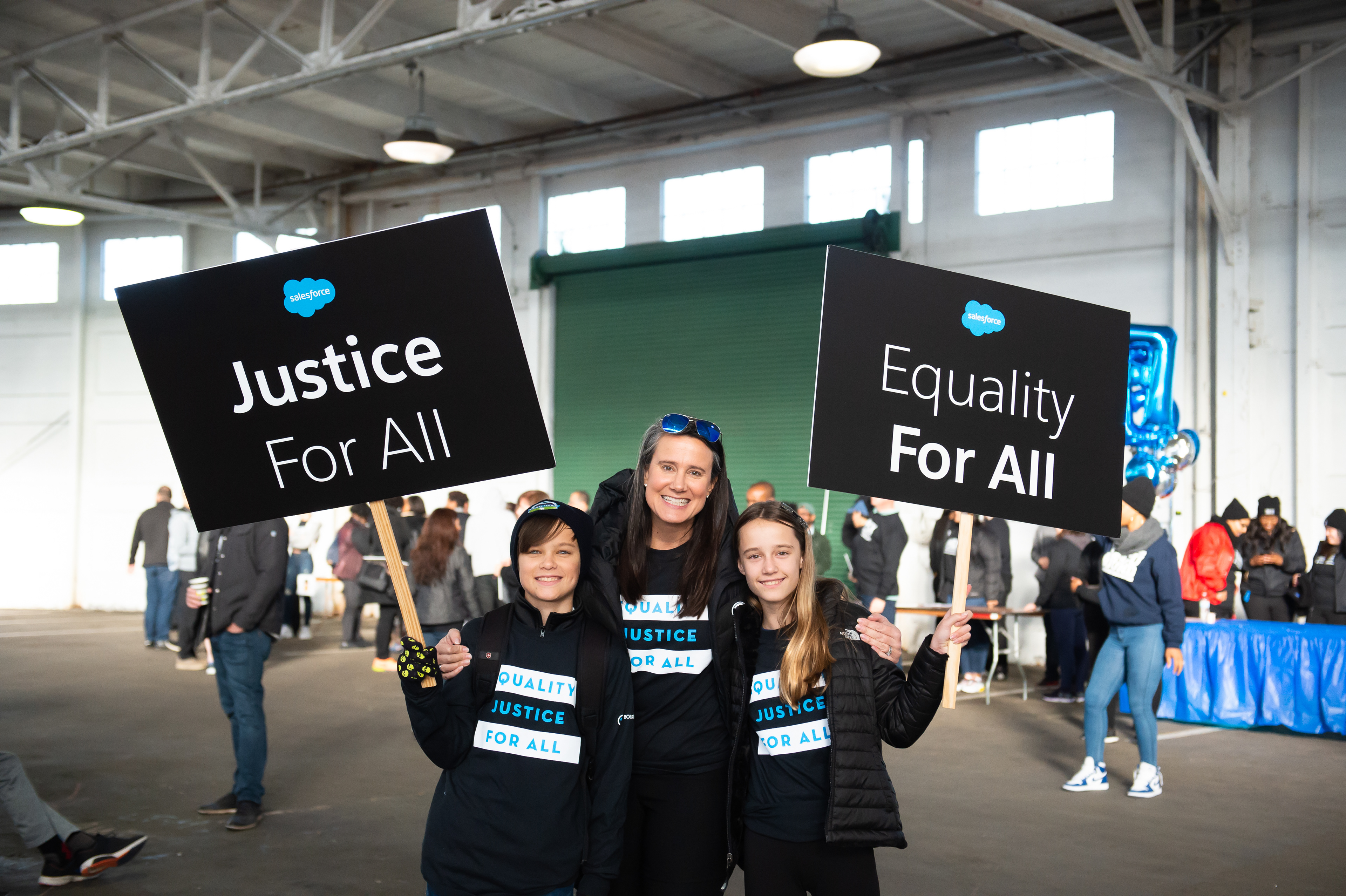 Family posing with signage and t-shirts