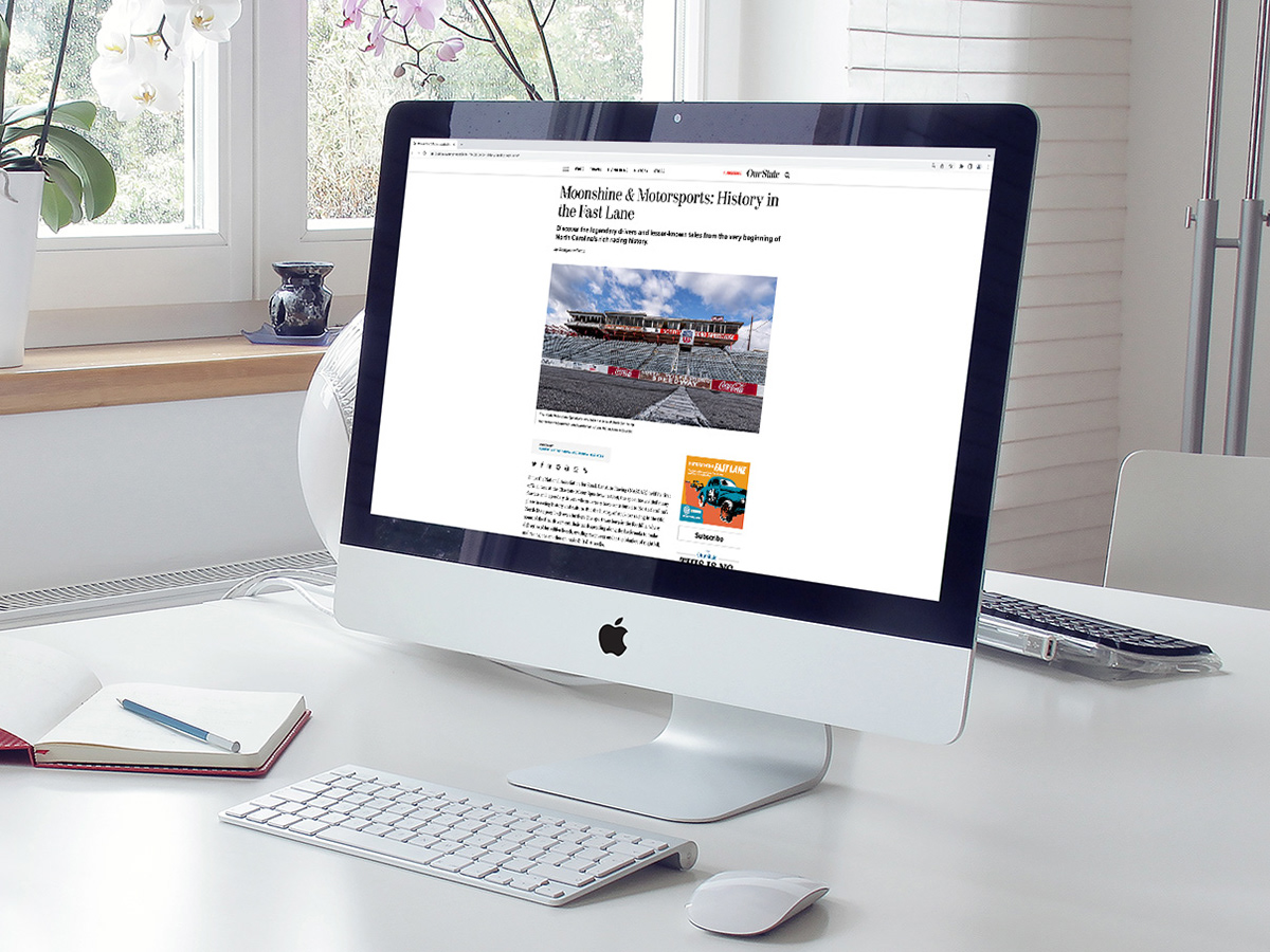 A Computer monitor on a desk displaying an online article with a digital ad shown.