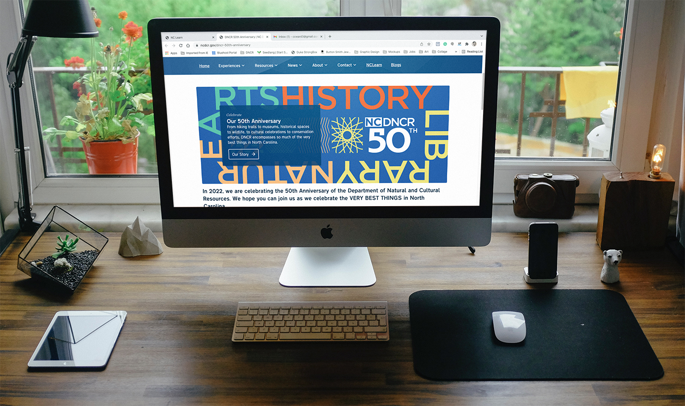 A desktop computer showing a landing page with 50th anniversary banner.