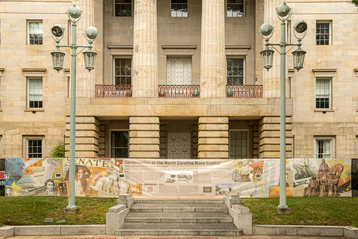 The fence screen installation displayed in front of the main entrance to the State Capitol