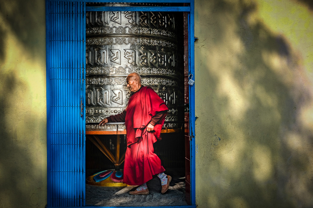 Monk spins prayer wheel Kathmandu Nepal
