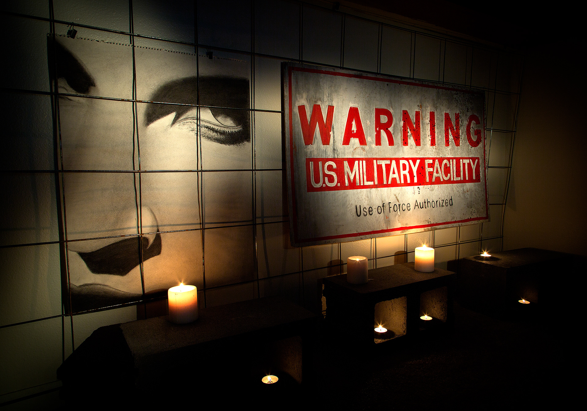 The "Warning" sign was created by someone in the art department. I drew the face on the left. It is not a film prop.