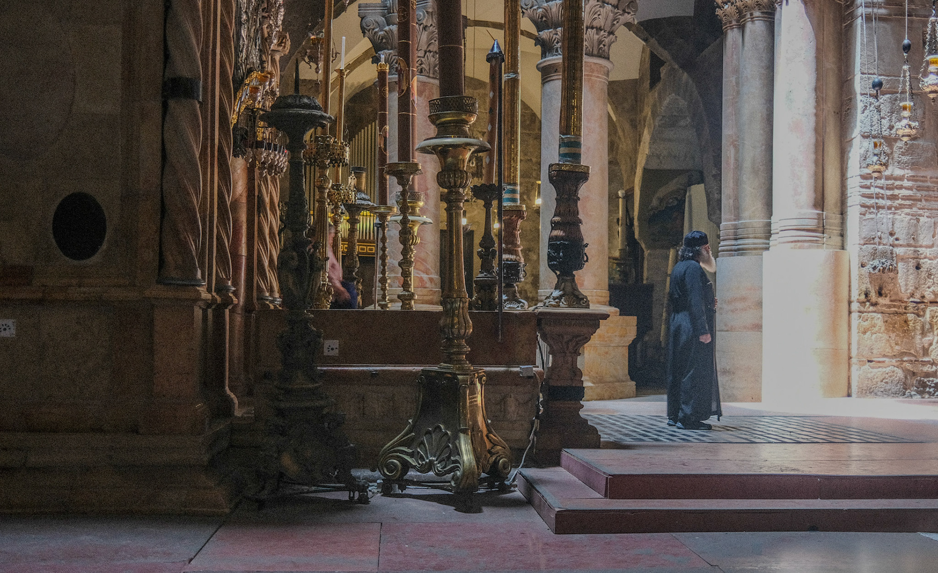 A priest waits for the faithful at the church of the Holy Sepulcher