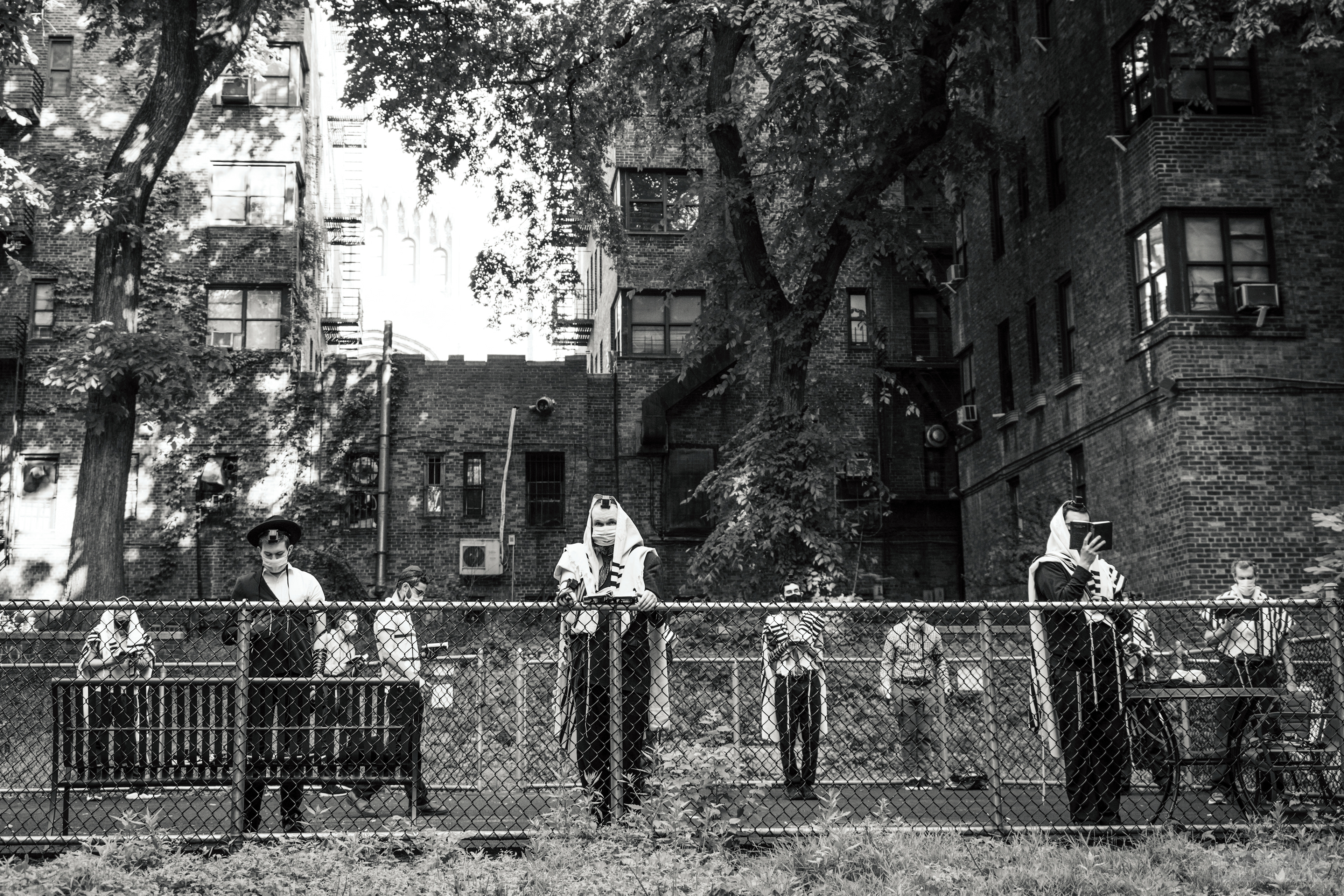 Men in the Washington Heights Modern Orthodox community, including some Yeshiva University faculty, holding an outdoor shacharit (morning) service. (New York, NY. 2020)