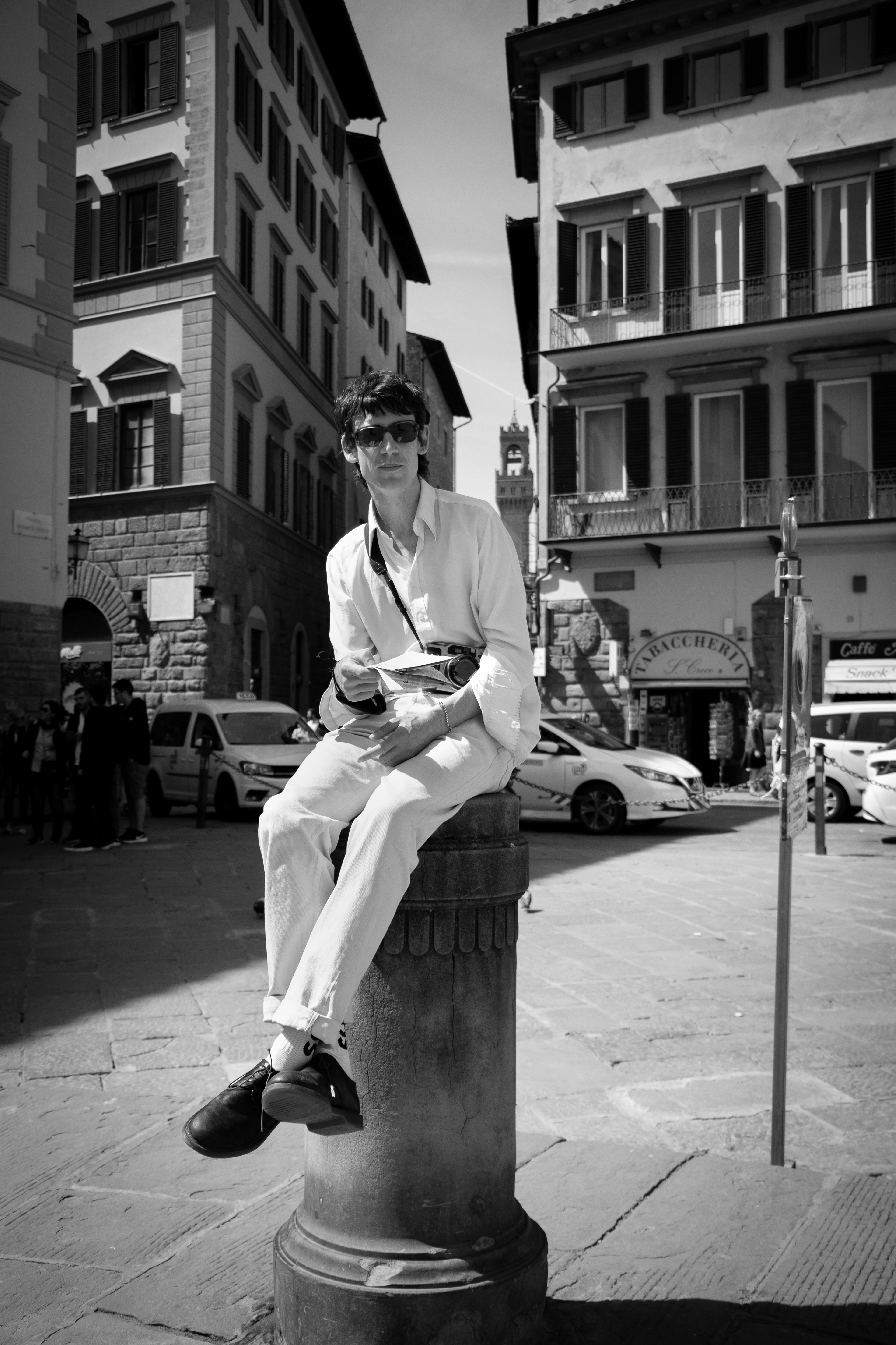 Being a tourist in Firenze can be tiring and finding a good place to sit outside when the weather is nice can be even harder. This tourist from England found a perch atop a pillar in Piazza Santa Croce
