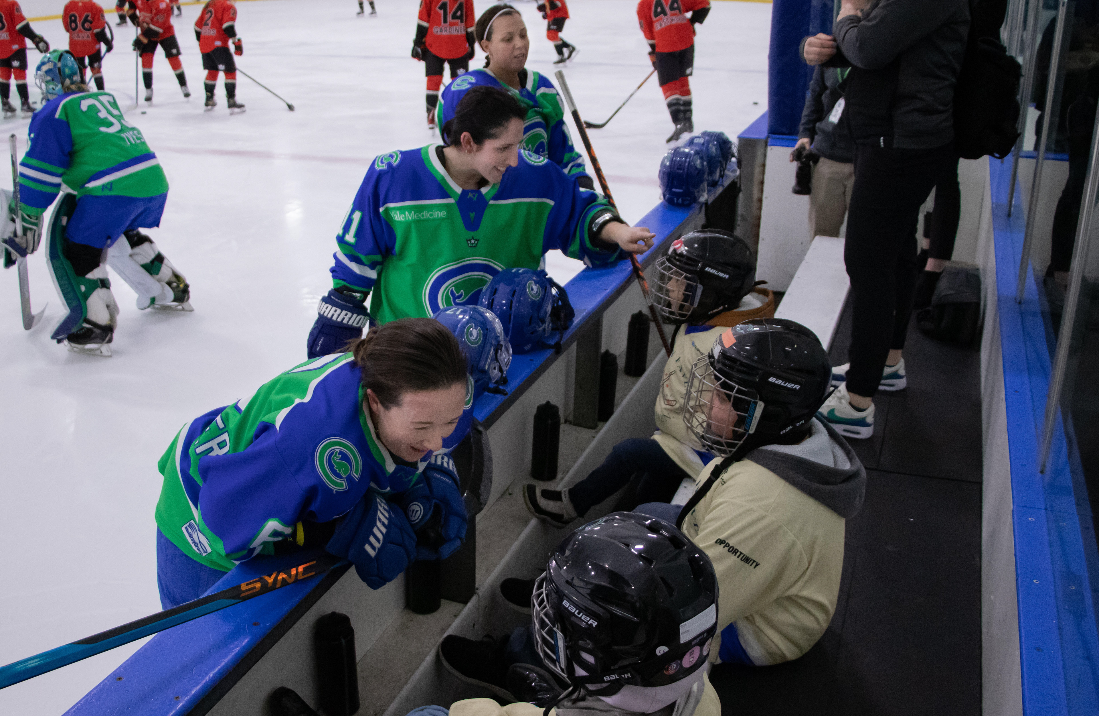 Role Models - The players on the Connecticut Whale are able to be role models for young hockey players. Shannon Turner (6), Melissa Samoskevich (11), and Taylor Girard (17) talk to young skaters from the Hockey Haven, New Haven, CT non-profit organization who got the chance to sit on the bench while the team warmed up before their game on Sunday, Feb. 19, 2023. The non-profit was created by medical students from Quinnipiac University in order to make hockey and equipment more accessible to children.