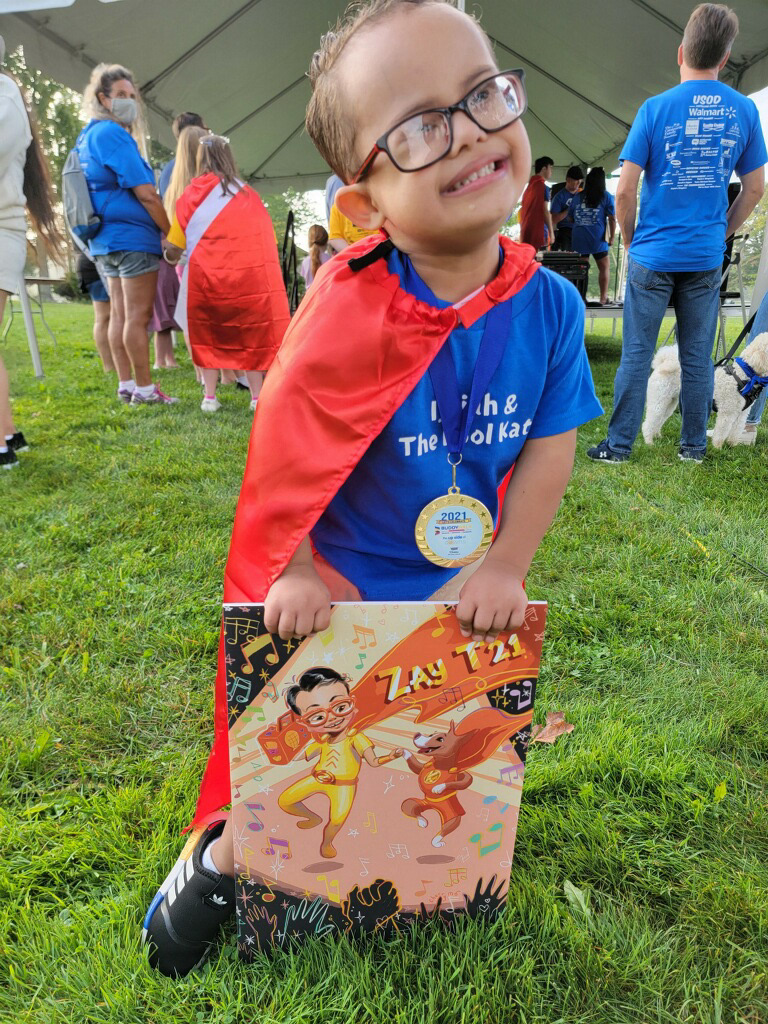 https://www.superheroprojectkids.org - The original Superhero happily receiving his poster.