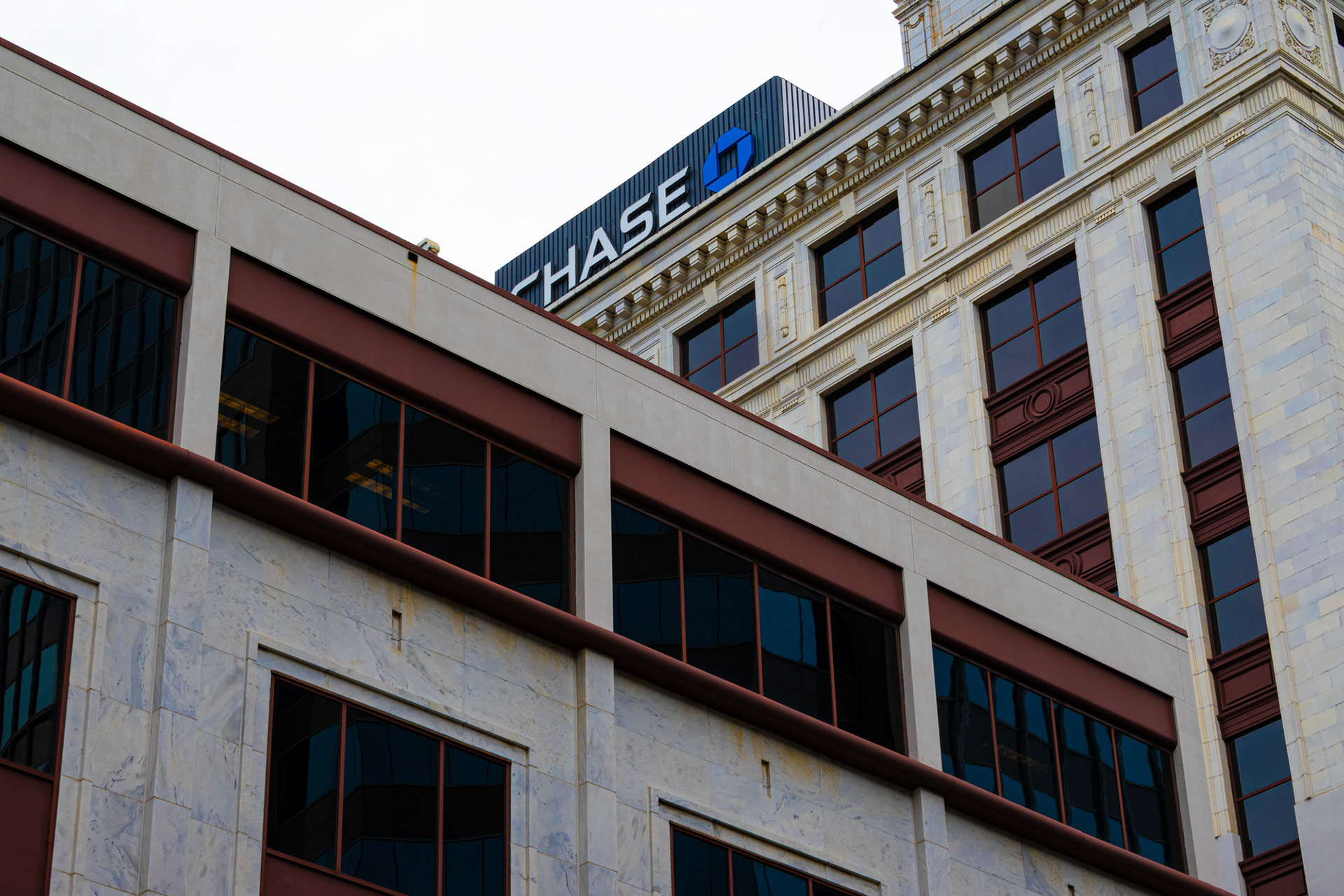 Photograph of the Chase Building surrounded by other buildings.