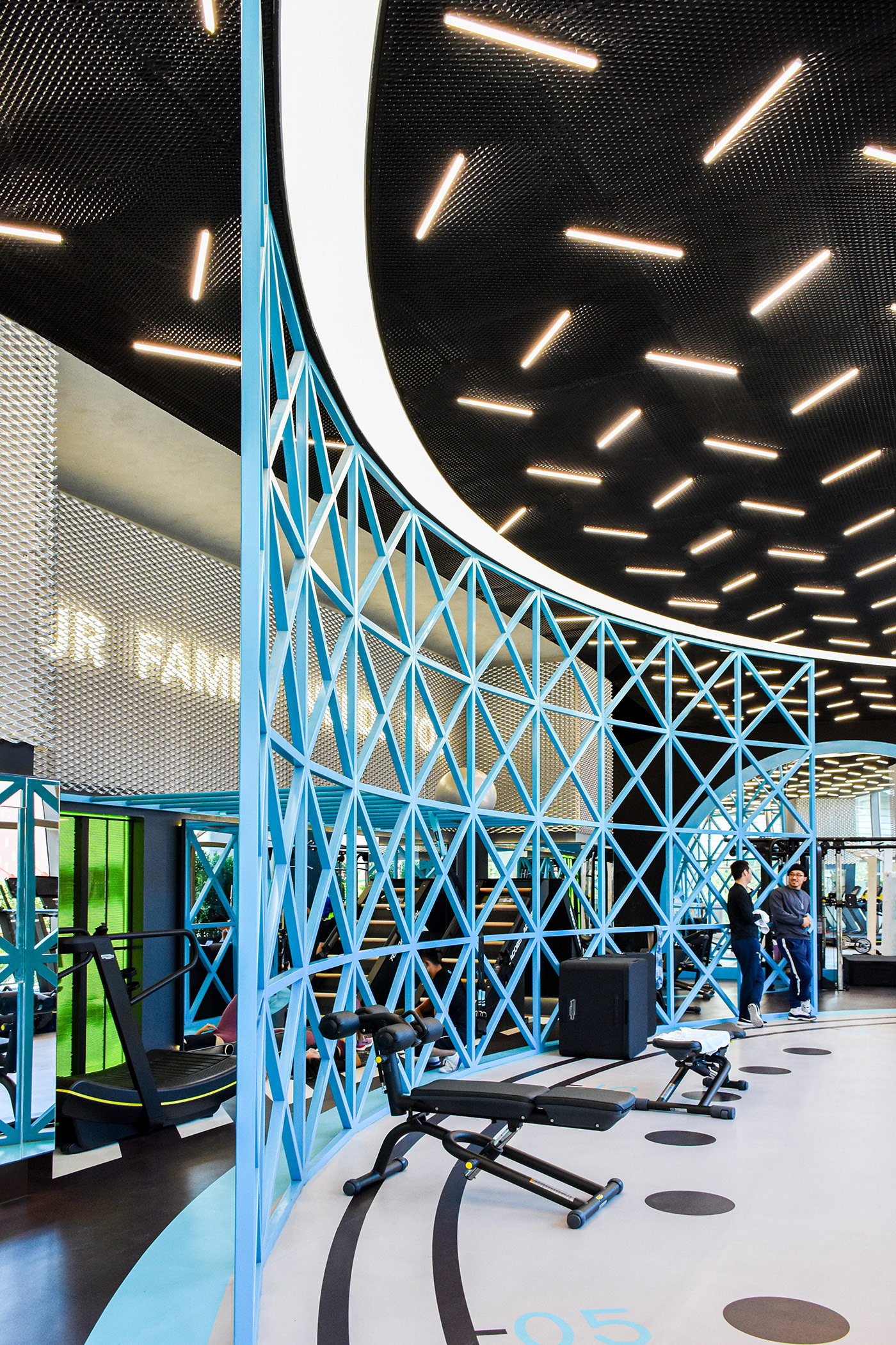 MFIT SPACE the large light blue colored lattice iron structure works as partition and training tool design by RAMOPRIMO