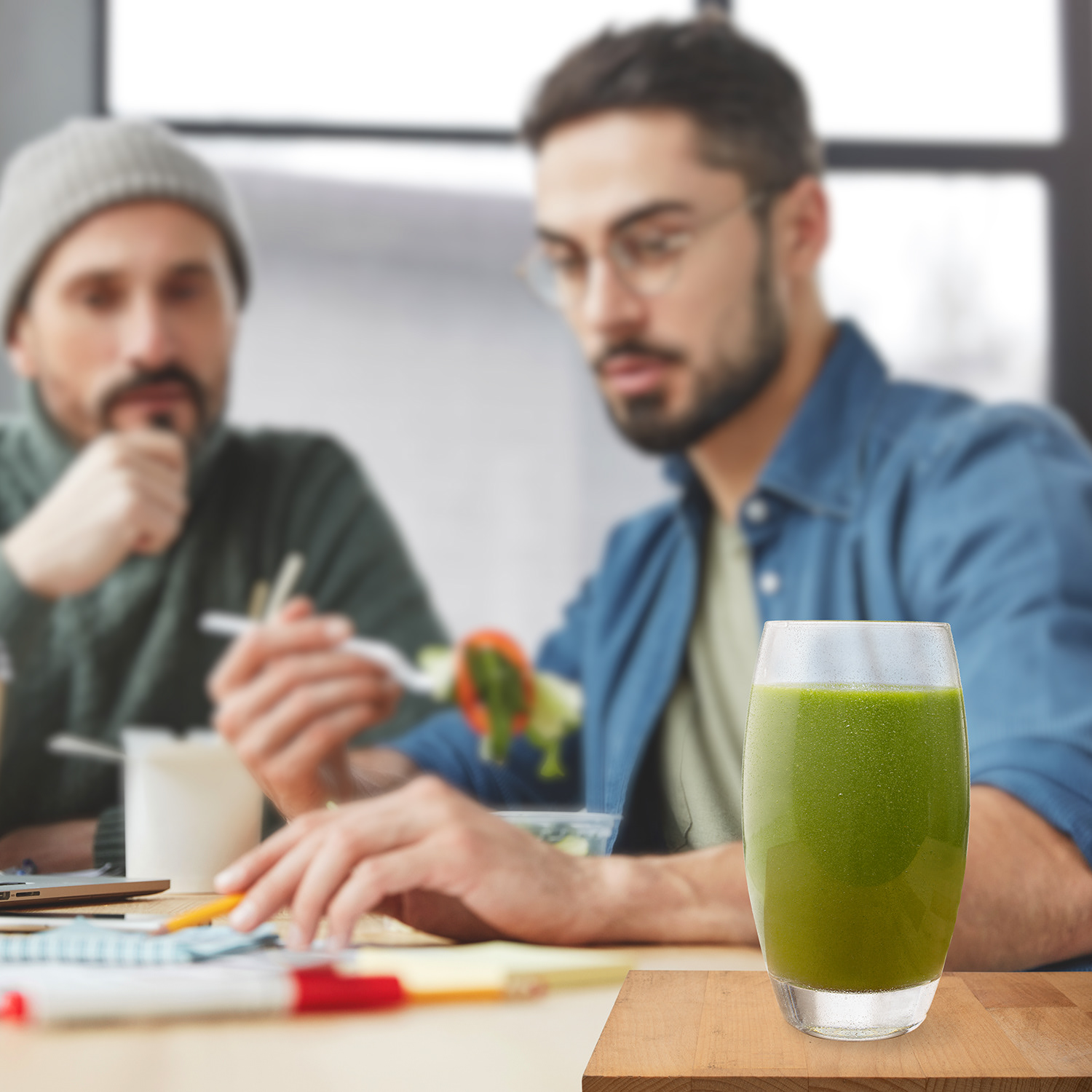 Clutch Smoothie compositing of green veg vegan smoothie glasses with stock image of two men working while having lunch