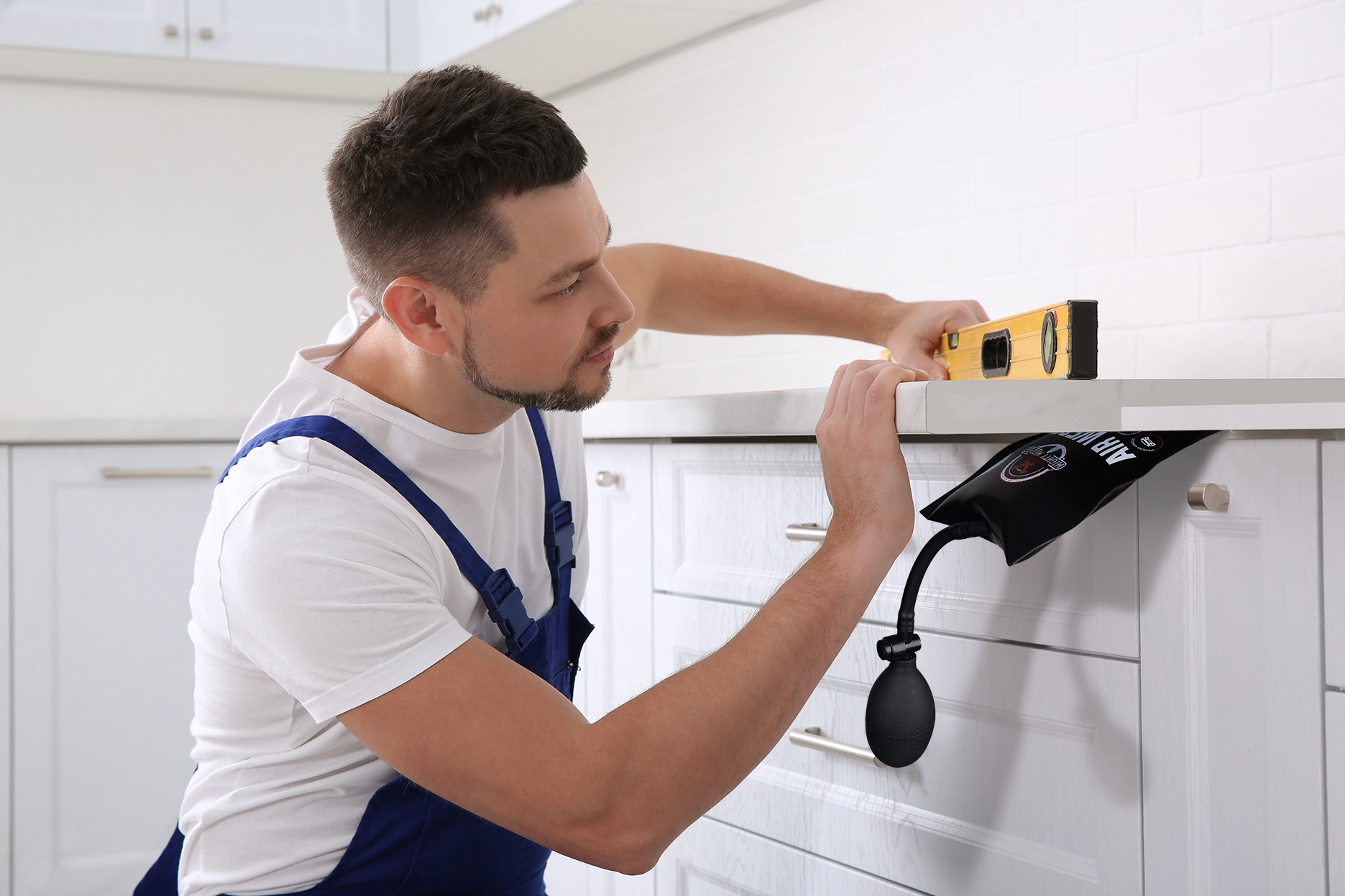 Compositing of air wedge product with image of worktop installer. Product photography and retouching by Stefania Calderara