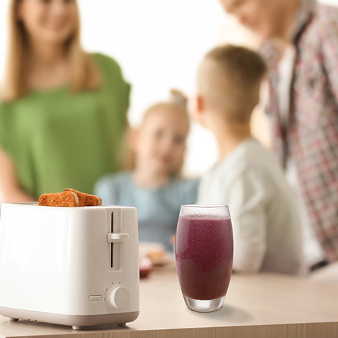 Clutch Smoothie compositing of red fruits smoothie glasses with stock image of family having breakfast
