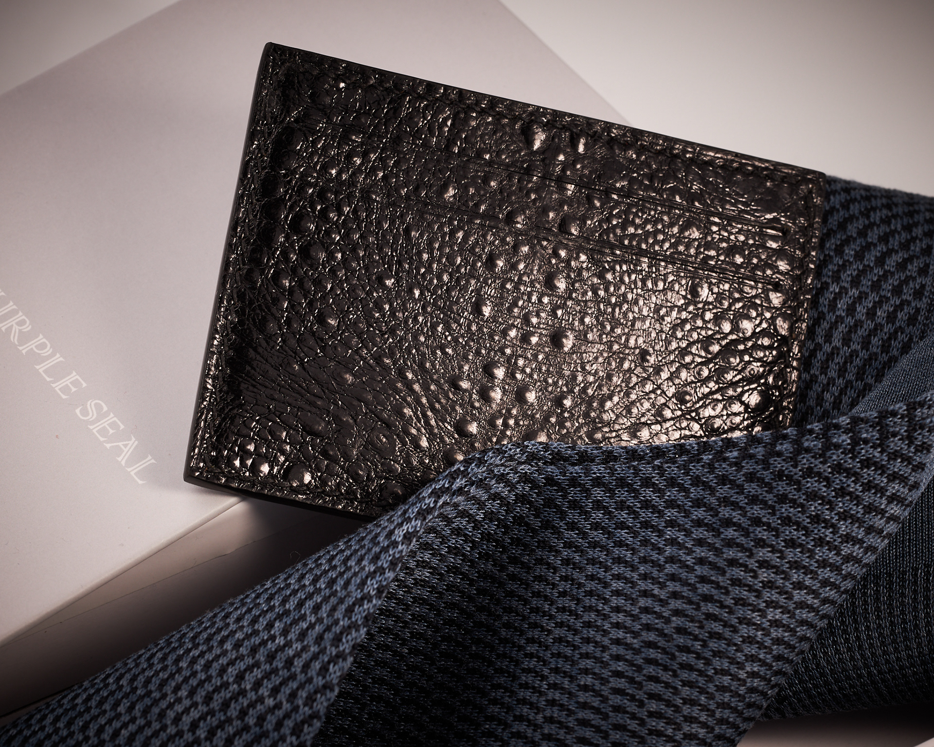 Luxury accessories Lifestyle image of leather cardholder and elegant dress socks by The Purple Seal - Black and Blue