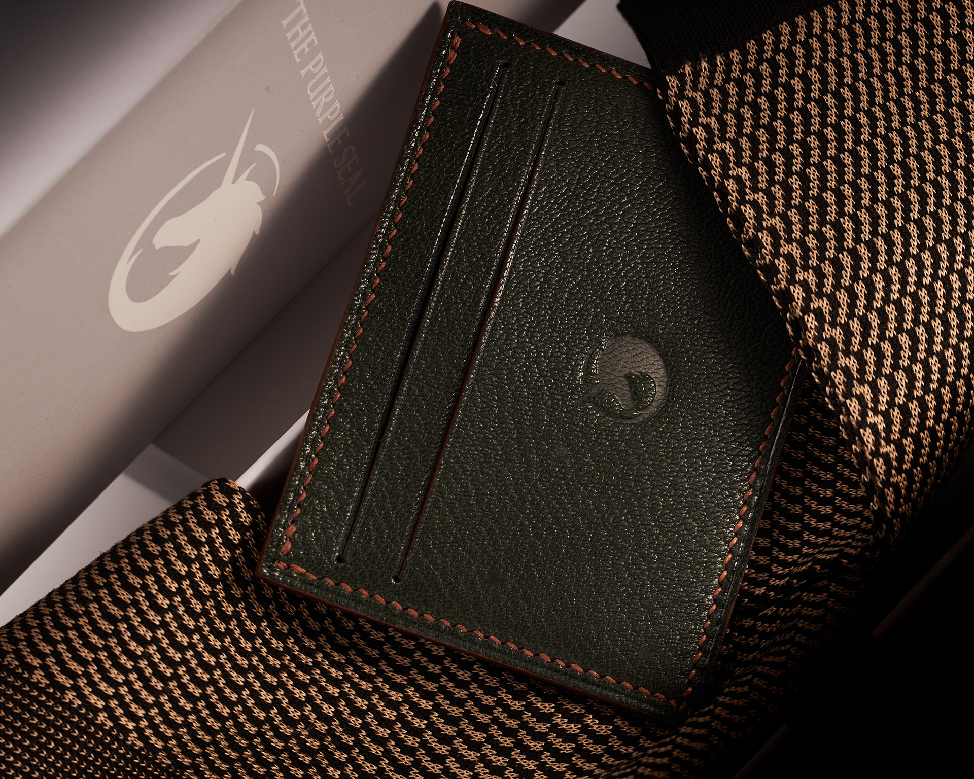 Luxury accessories Lifestyle image of leather cardholder and elegant dress socks by The Purple Seal - Green and Brown