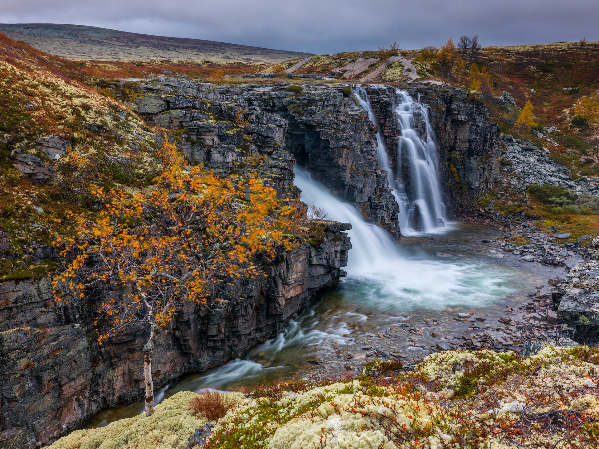 Autumn colors surrounds the Storulfossen in Rondane, Norway