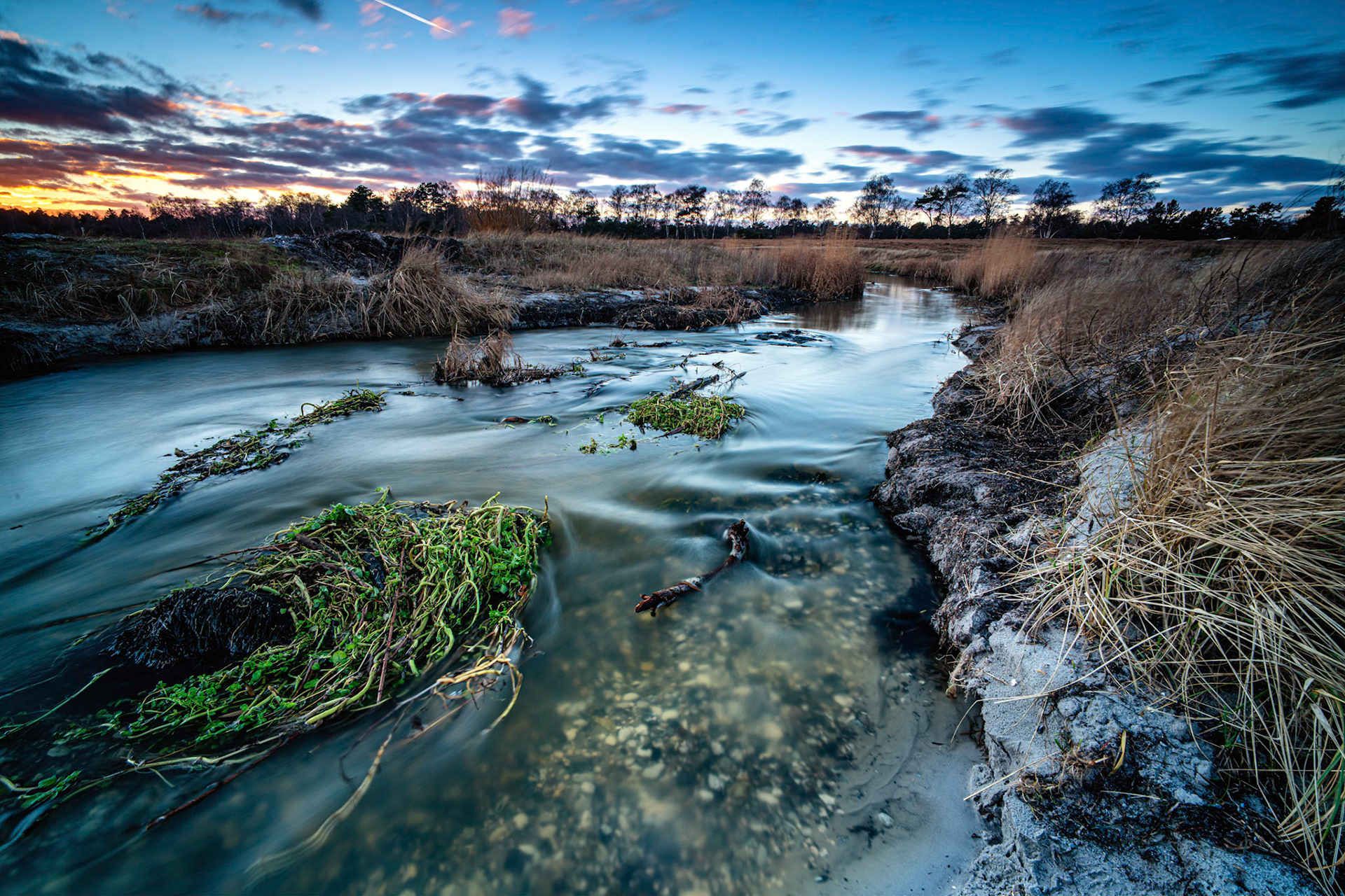 Finally staying in the rain so I could get out and test my new lens. Lots of water in Karlstrup Mosebæk so that a little movement could be formed in the water for a long-term exposure which could also give a little excitement in the clouds.   I'm impressed with the sharpness all the way to the corners, super lens at a reasonable price. Additional Exif: NiSi V6 filter holder with landscape circular polarising filter and graduated neutral density filter at 4 stops. Sirui R-2214X tripod with Sirui Ball Head K30-II.