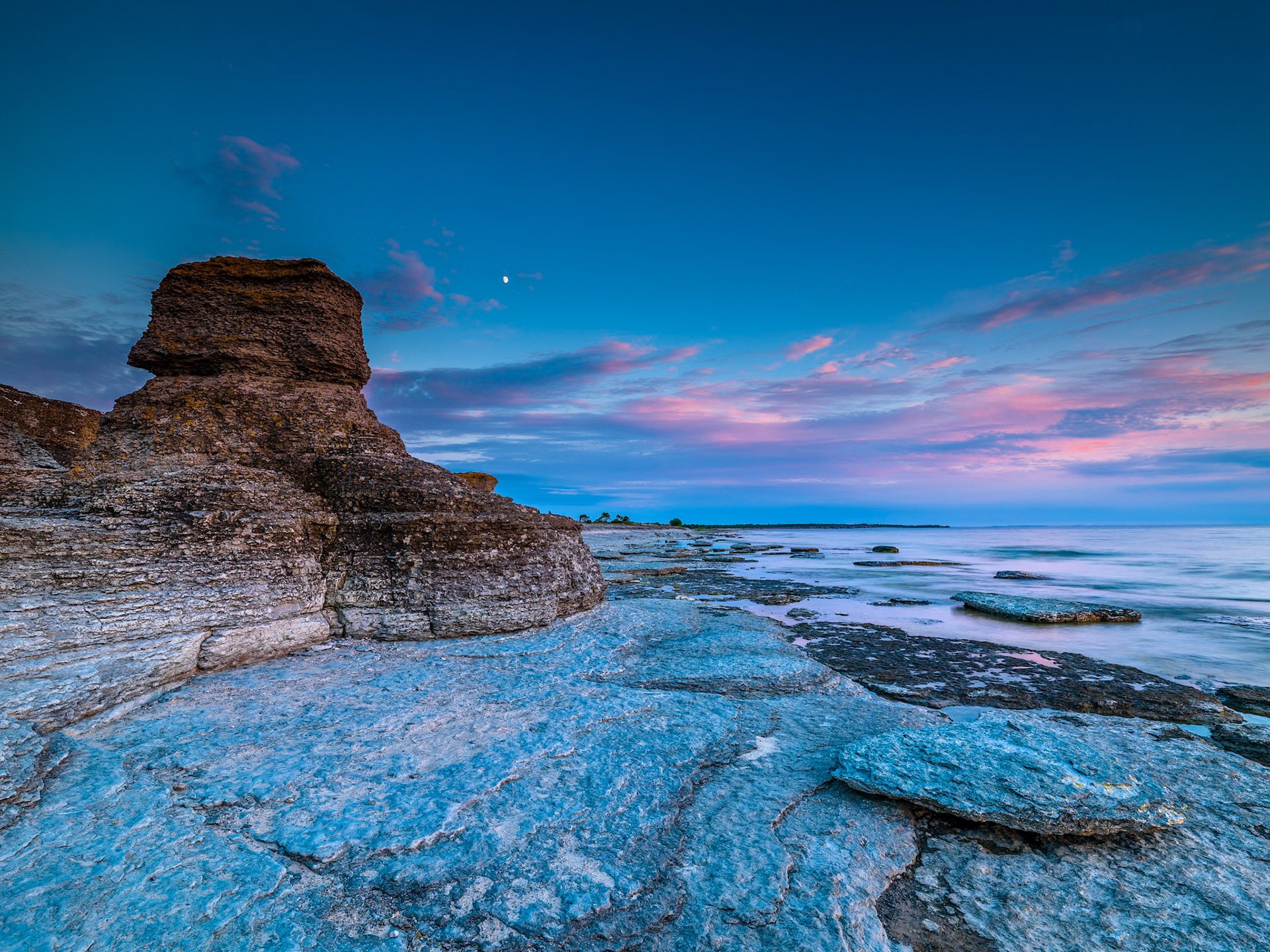 The cool light hit the Rauker while the moon hovers high above. Byrum at ôland in Sweden